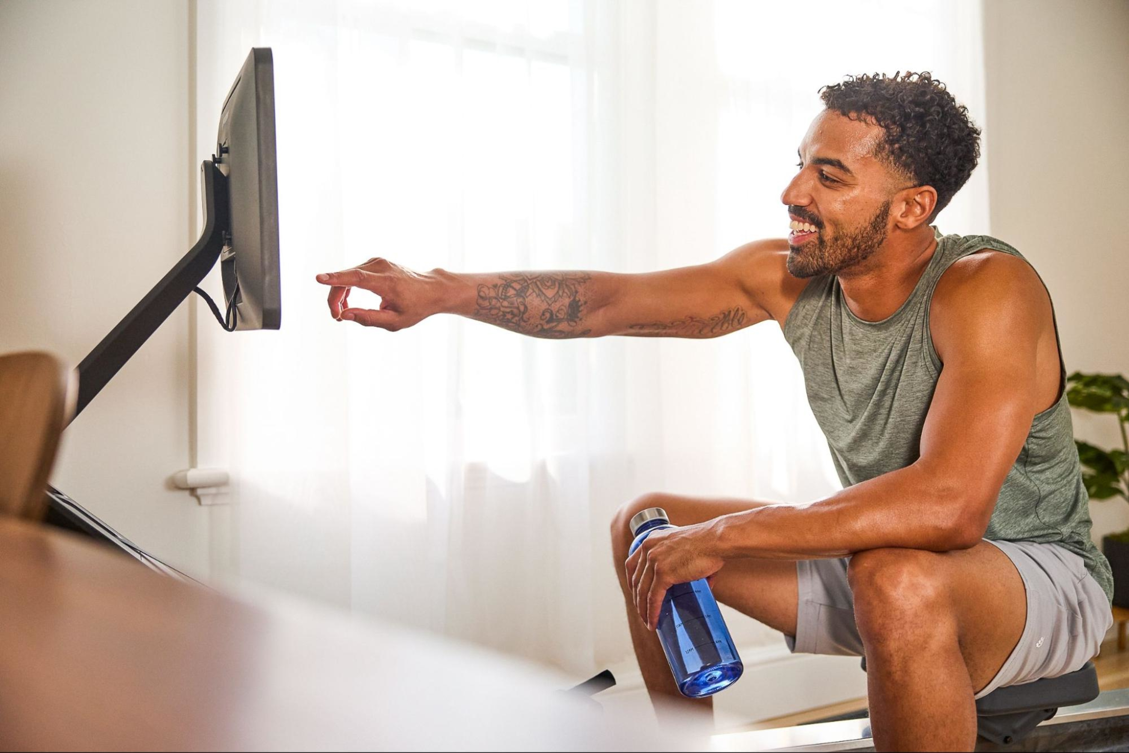 Man builds strength by doing a rowing machine workout.
