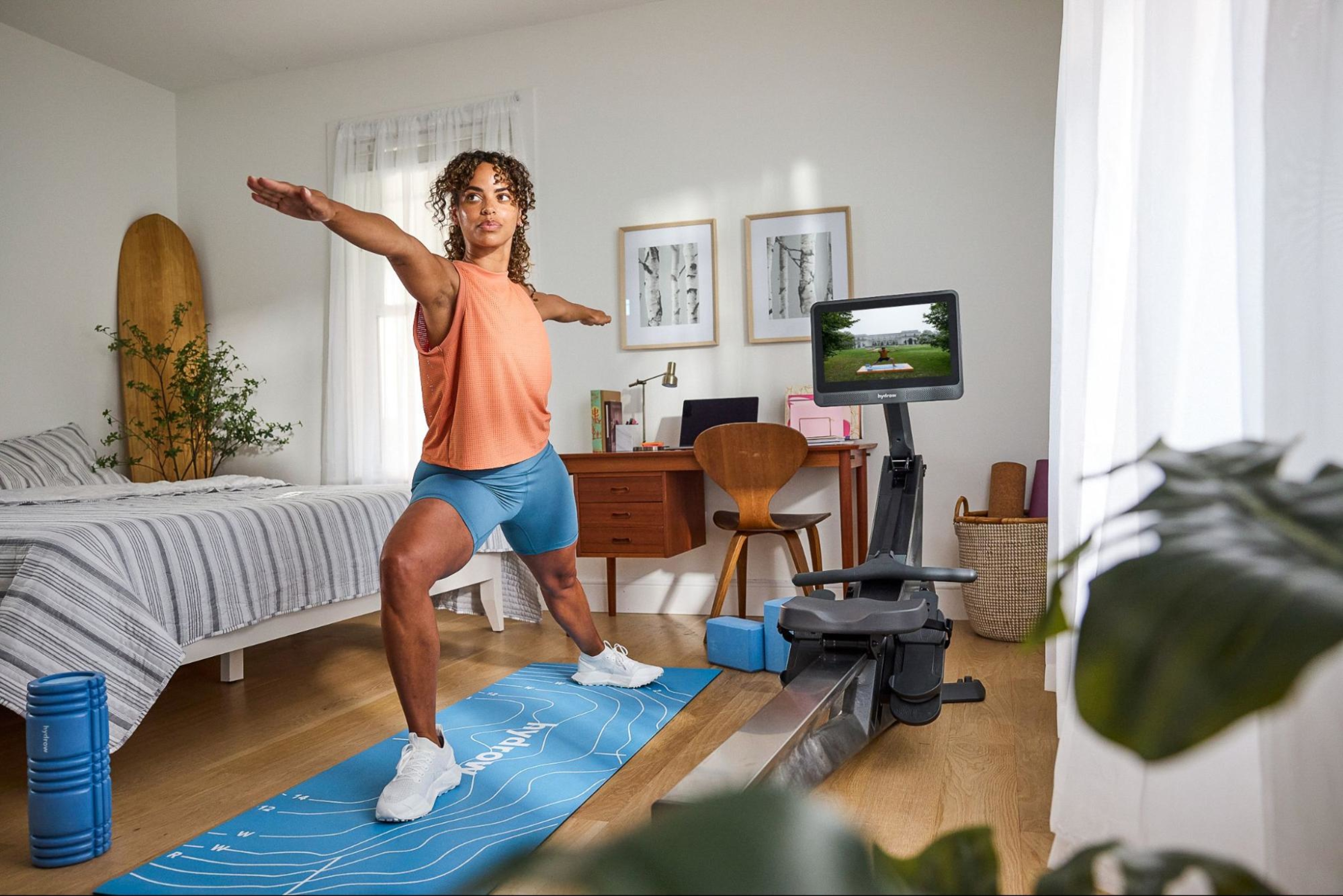 Woman works out at home after weighing the costs of a home gym vs. a gym membership.