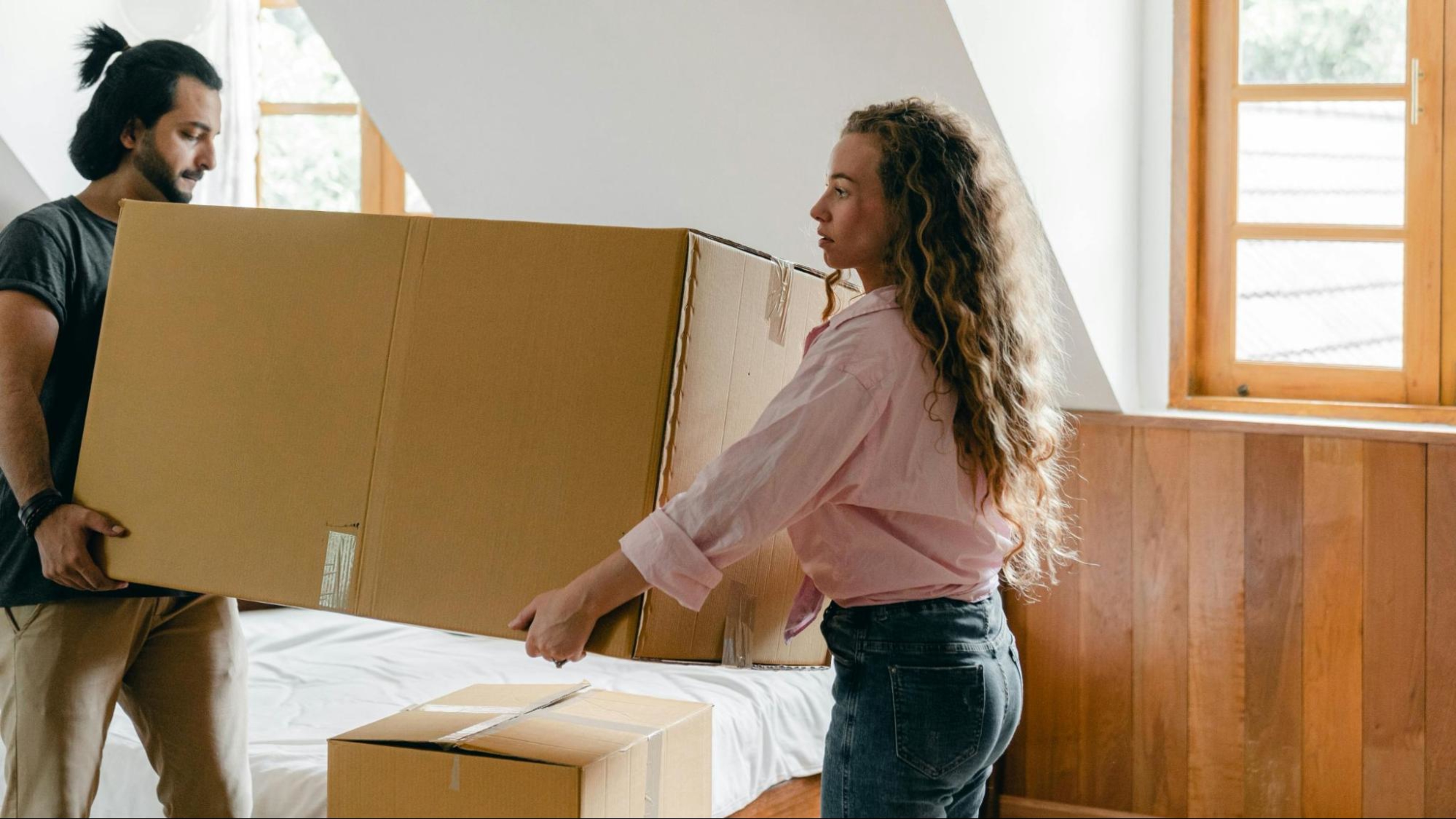Couple moves a box with at-home fitness equipment to build their own home gym.