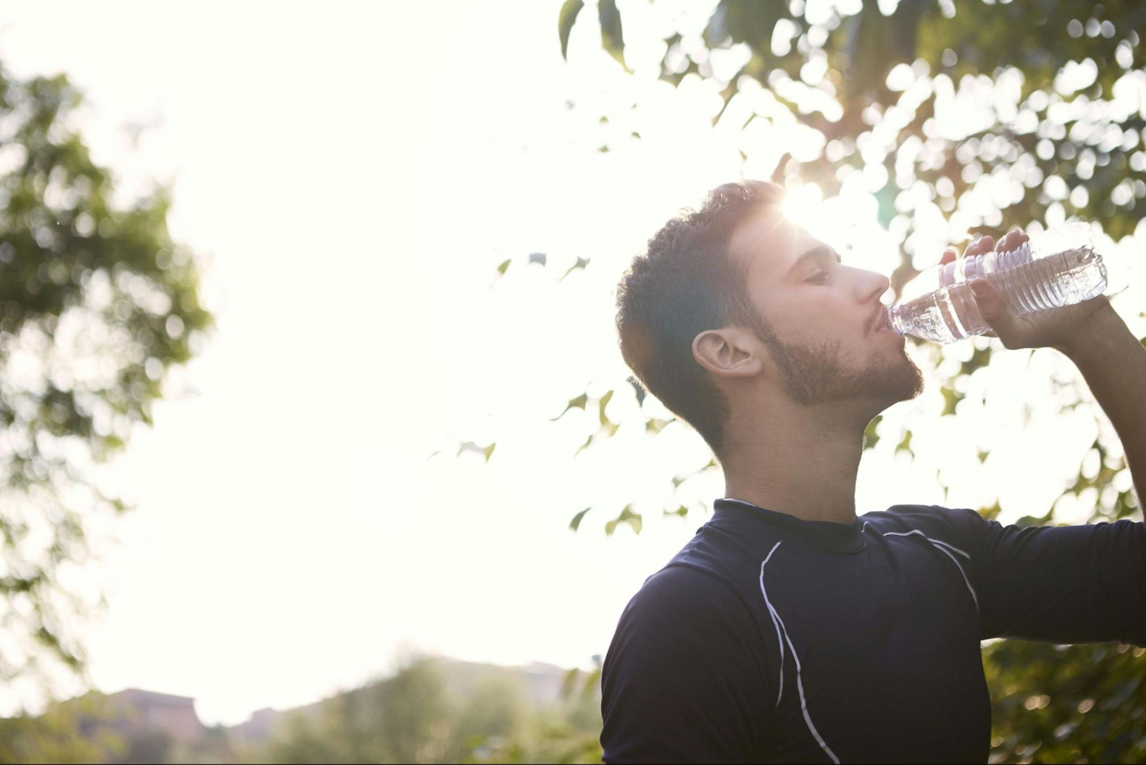 Man hydrates to stay safe when he's working out every day.