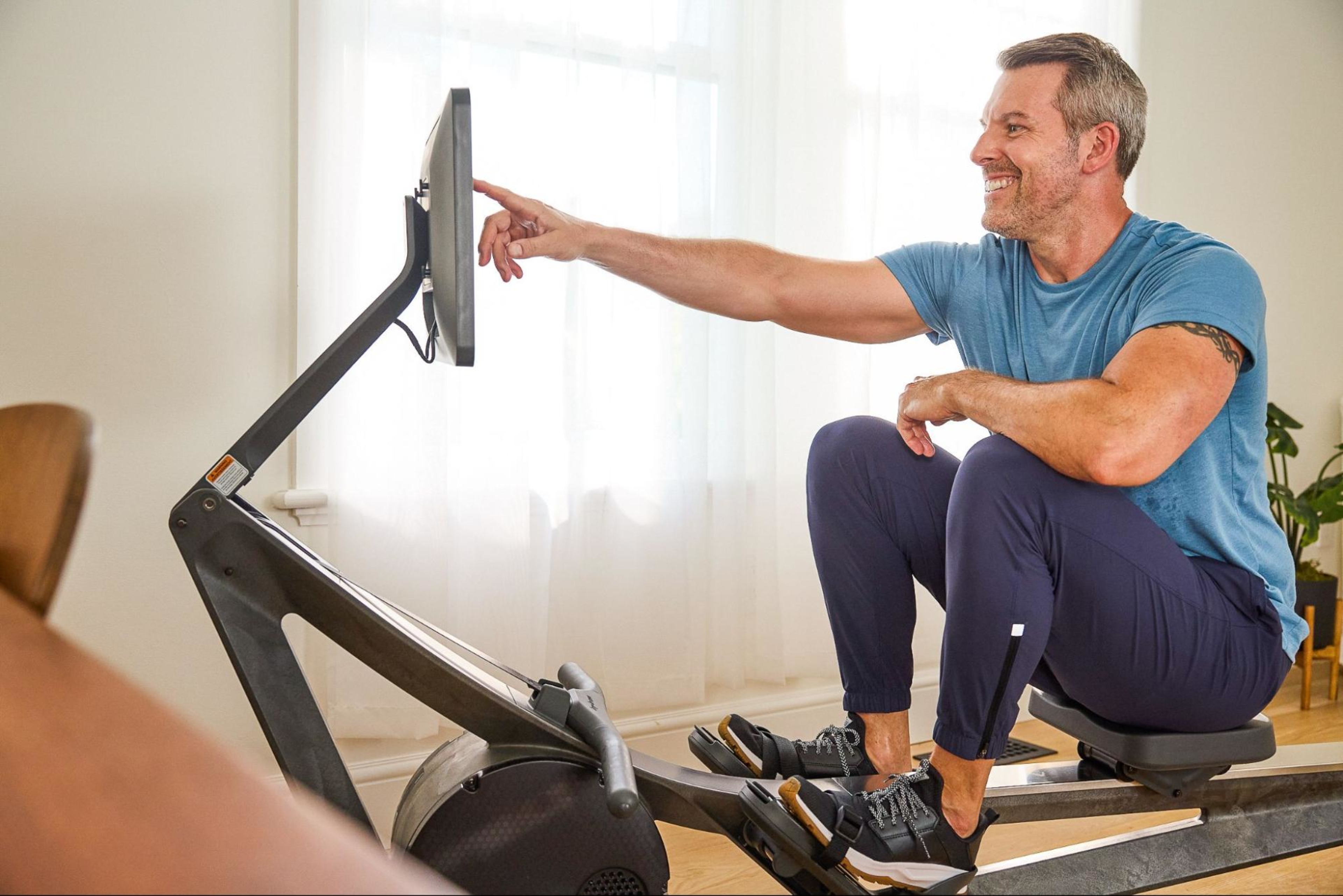 Man does a rowing machine workout after learning why he should work out every day.