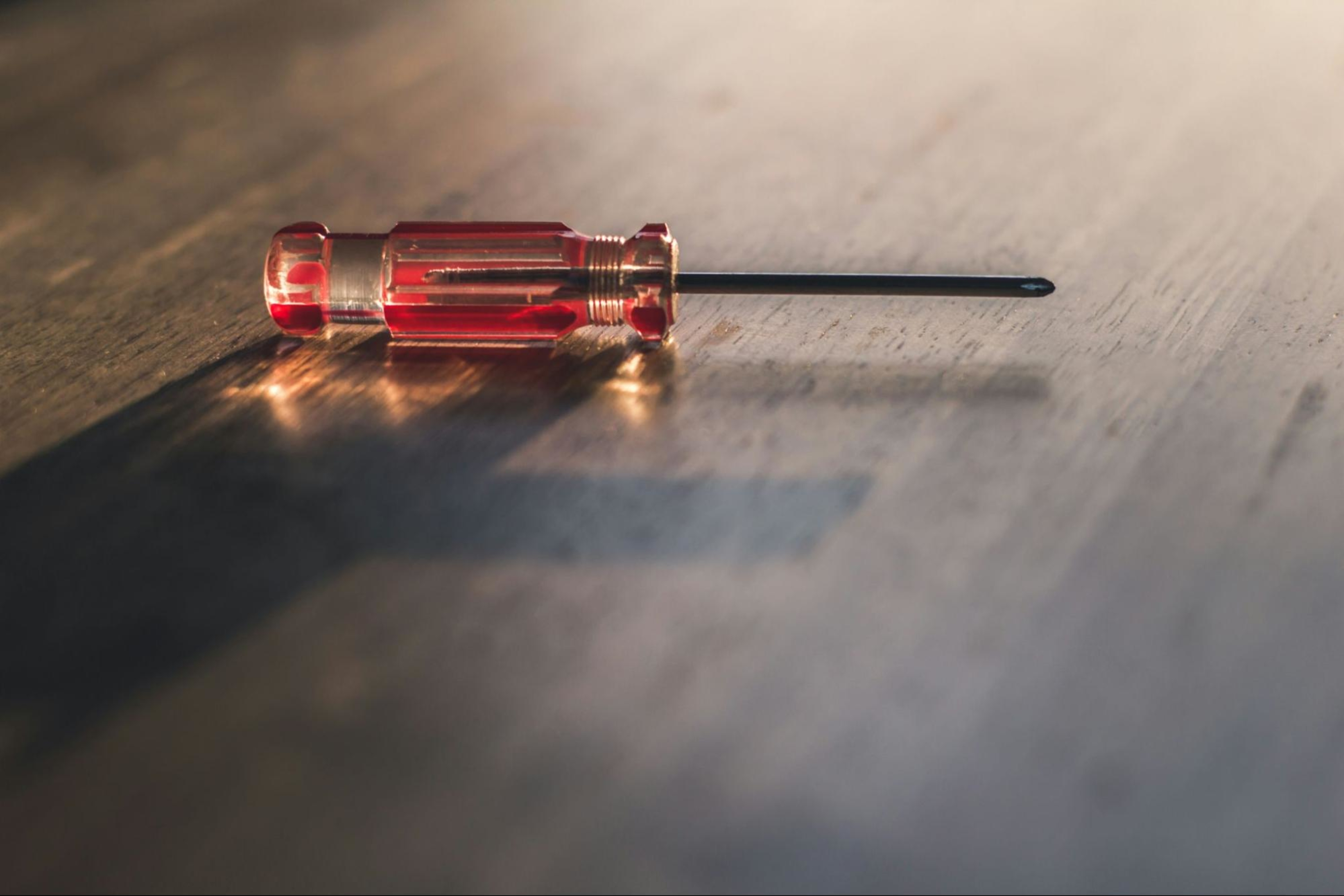 A screwdriver on a table, one of the tools you need to assemble a rowing machine.