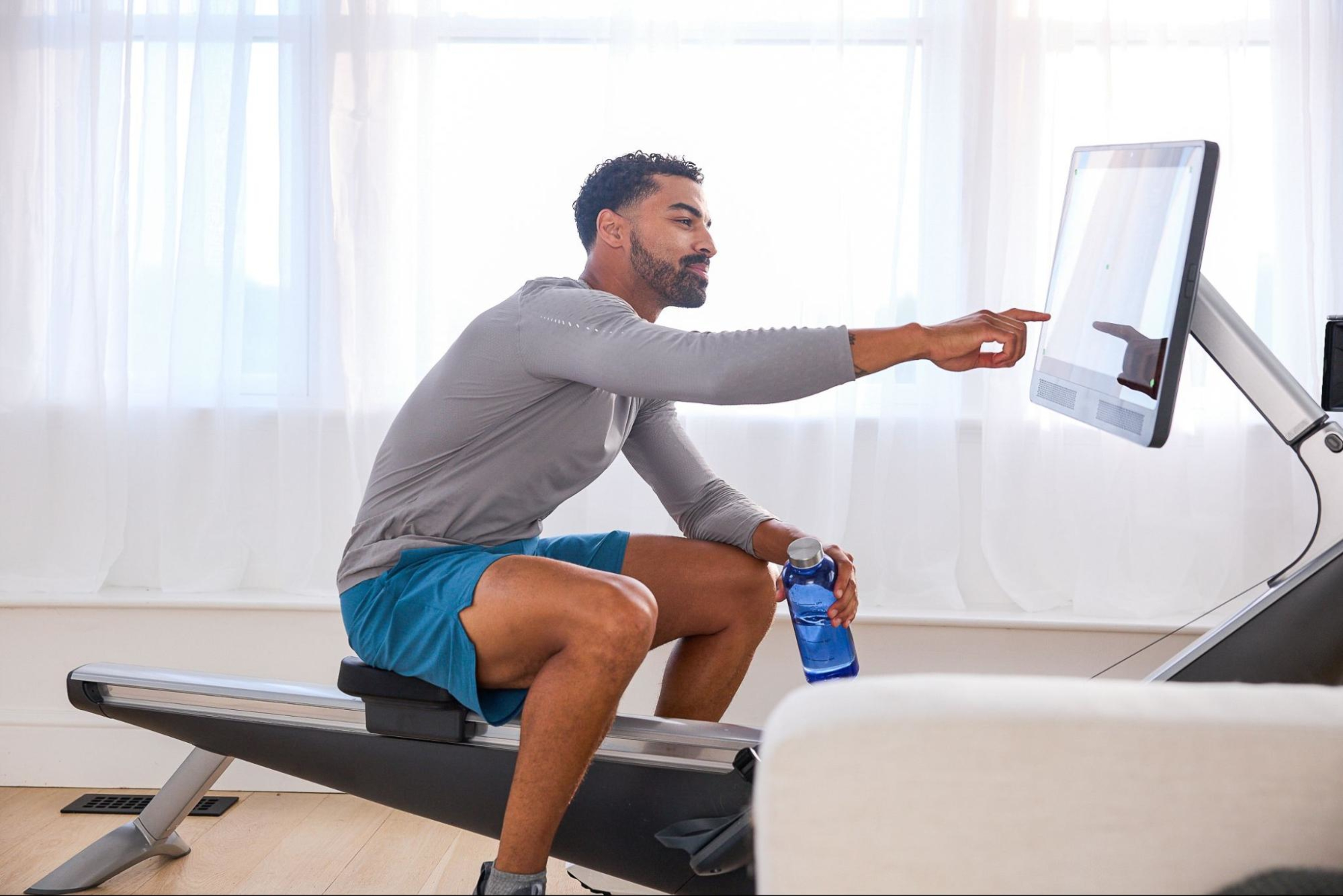 Man does a rowing machine workout after learning whether he should do weights before cardio.