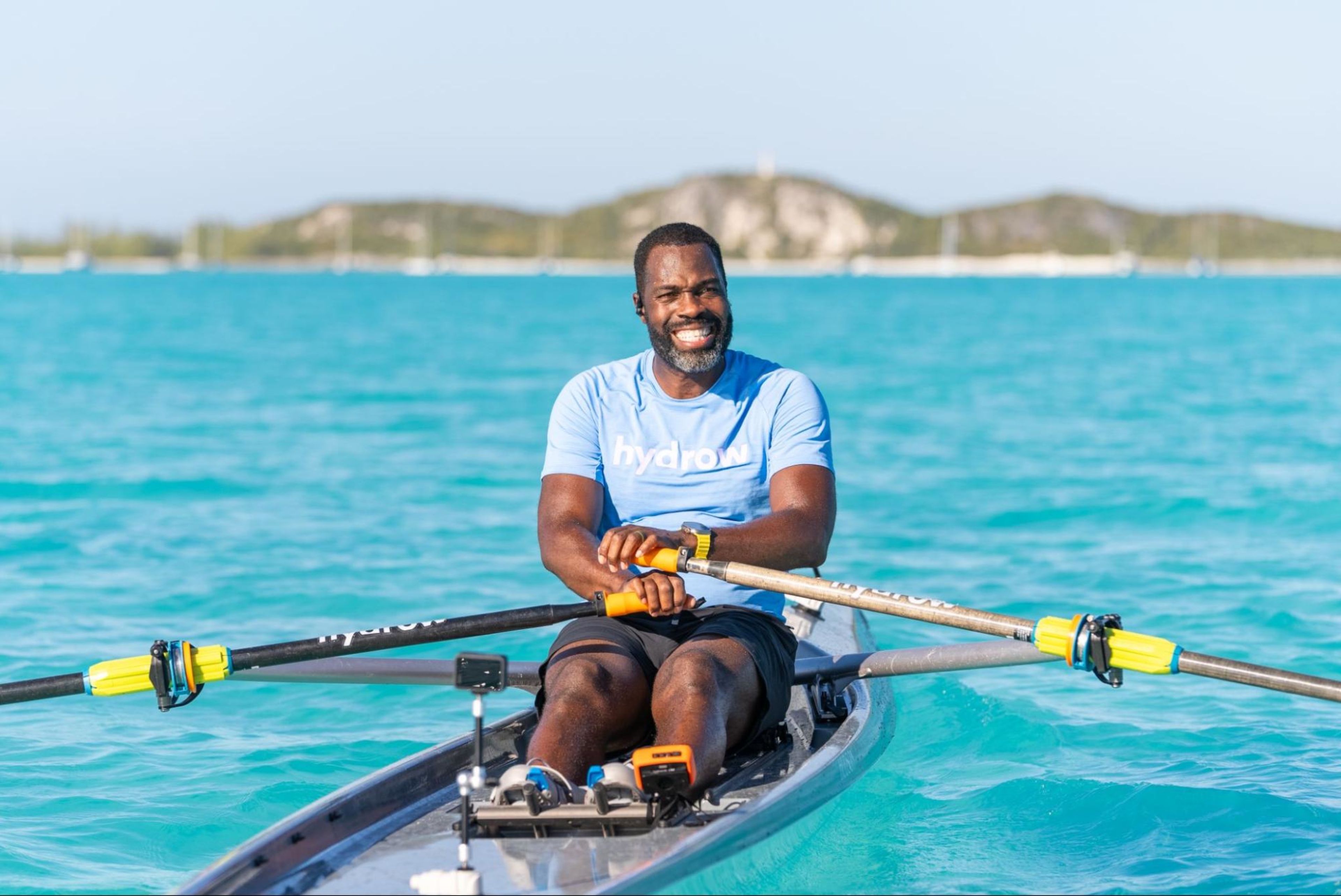 Hydrow Athlete leads a rowing workout from the Bahamas, which is not accessible without a Hydrow membership.
