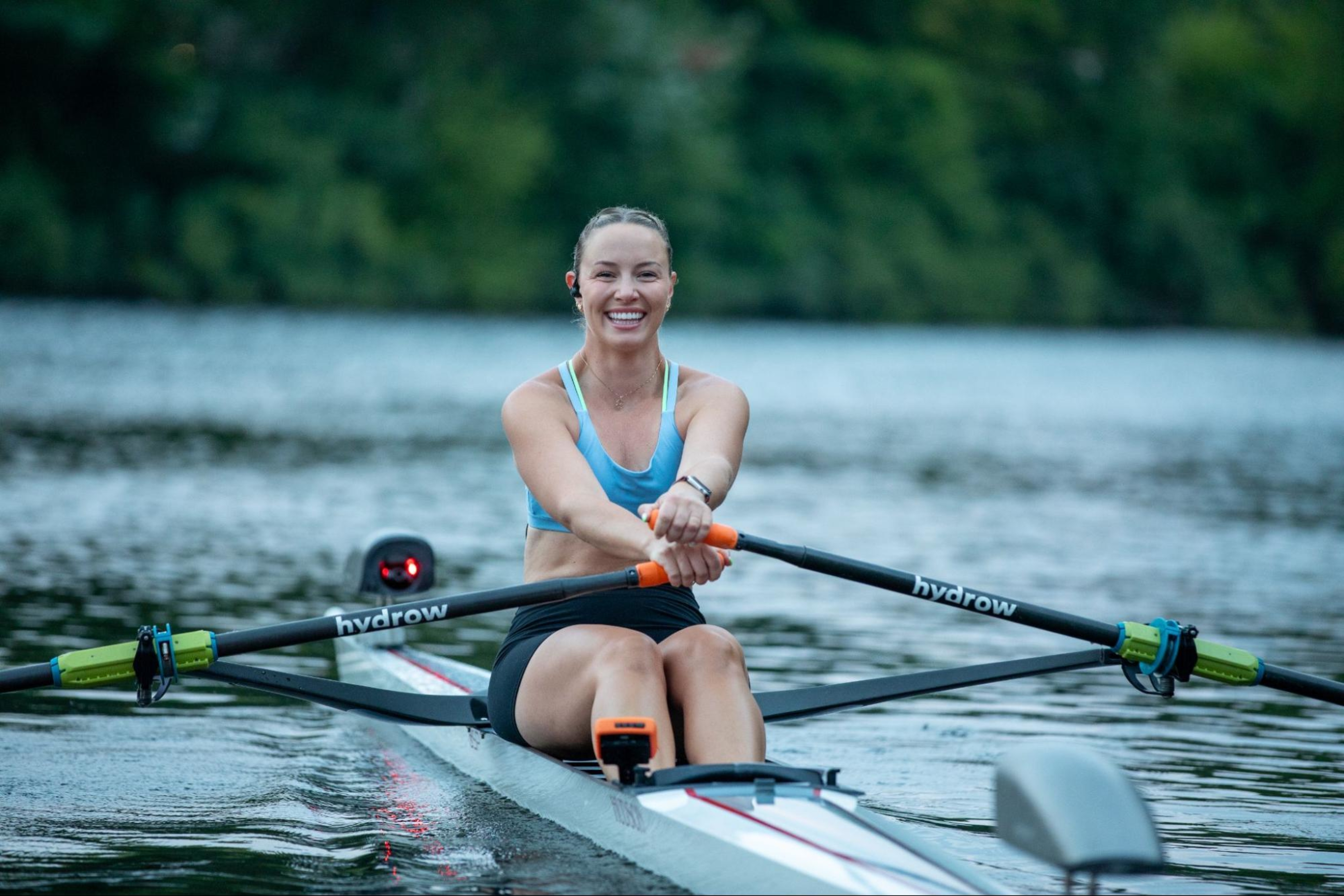 Hydrow Athlete leads a rowing workout on the water, one of the many reasons Hydrow rowing machines are worth the money.