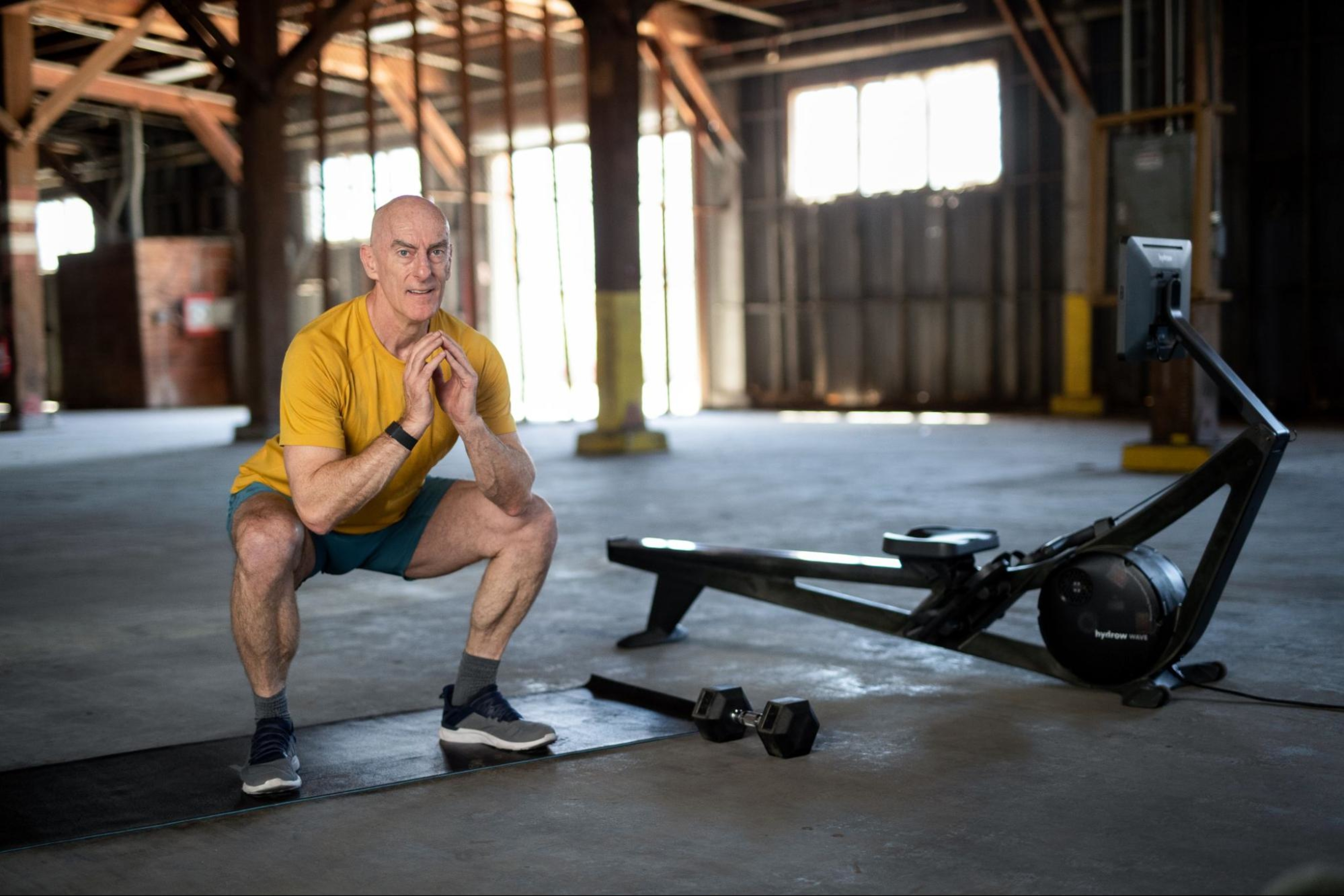 Man does squats to strengthen his core with circuit training.