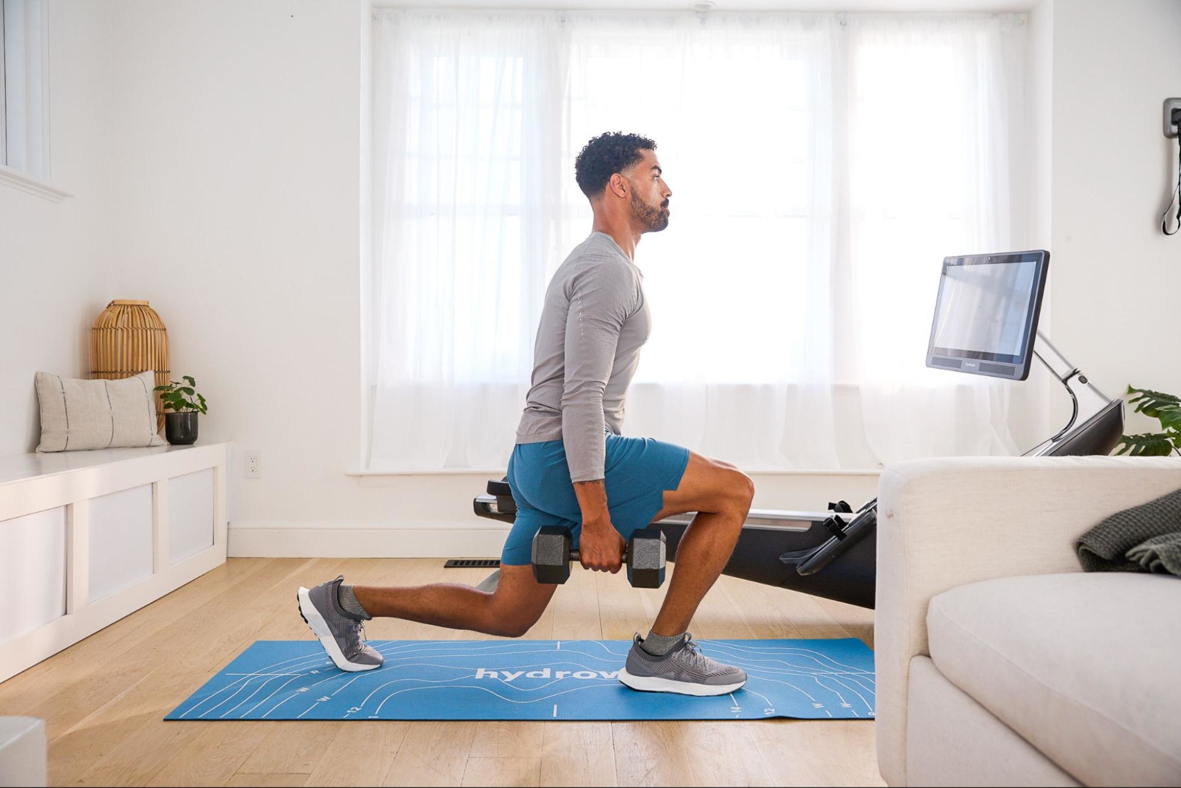 Man does a circuit training workout at home.