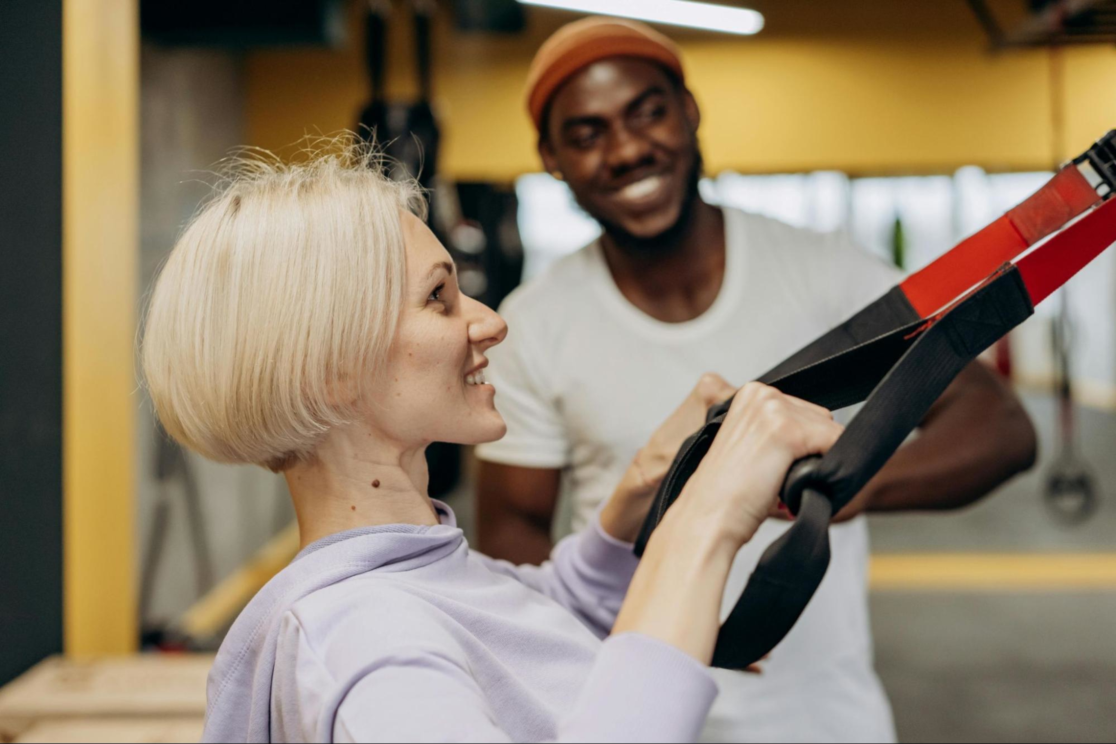 Woman works out with a personal trainer at a boutique fitness studio.