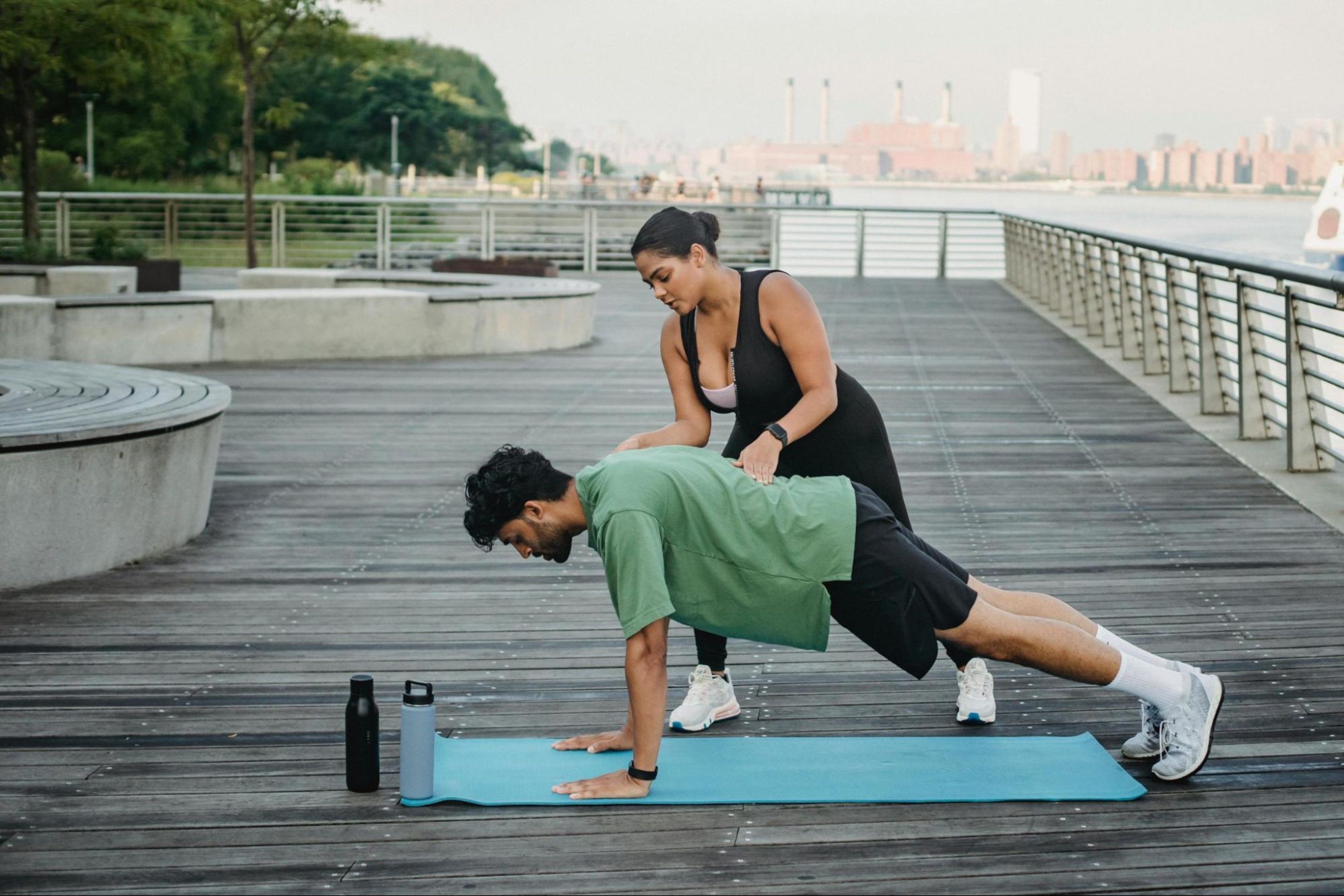 Man does strength training exercises outdoors to help improve his running.