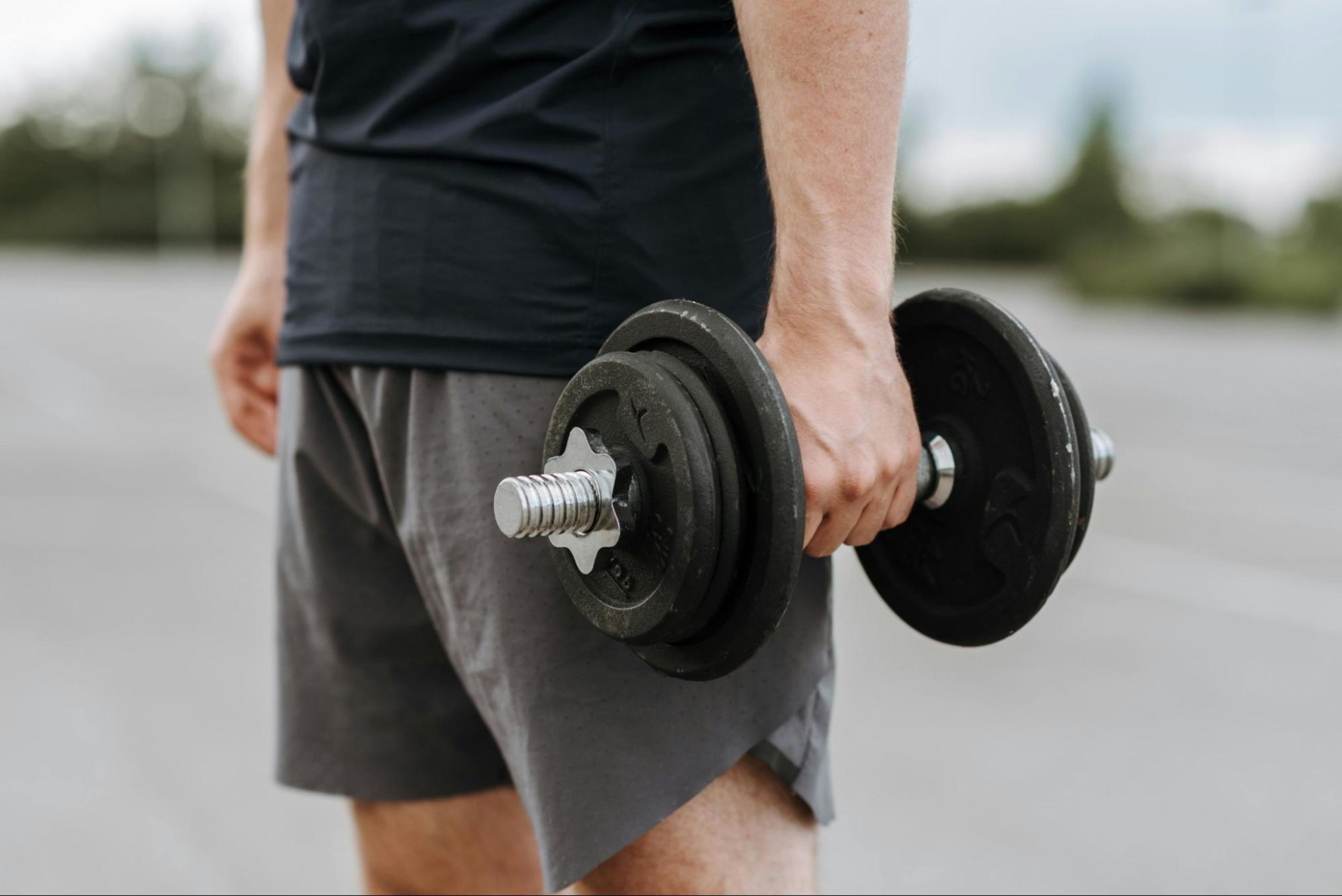 Man holds a dumbbell.