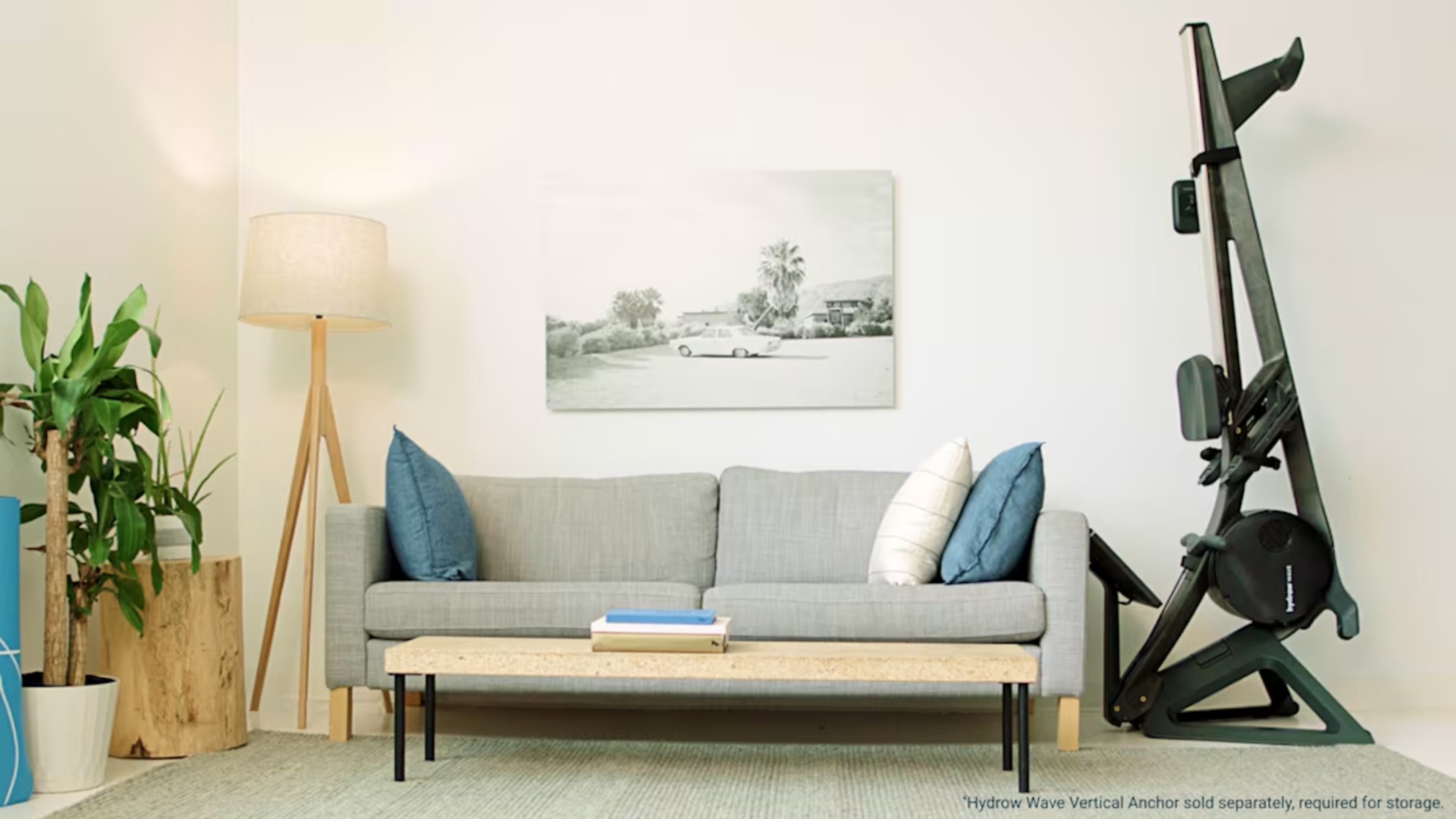 A Hydrow Wave rowing machine being stored vertically in a living room.