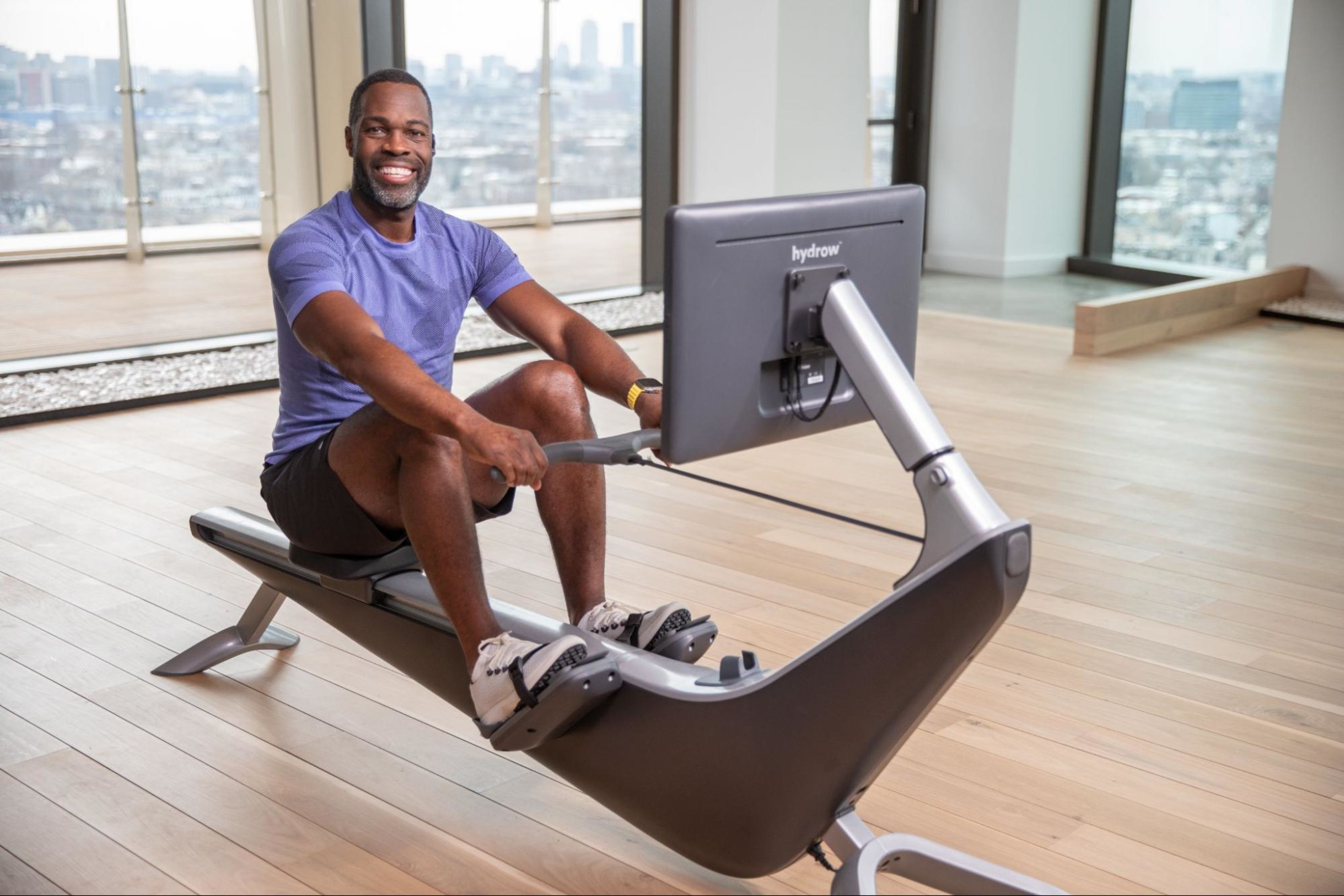 Man does a rowing machine workout as part of a workout plan for beginners.