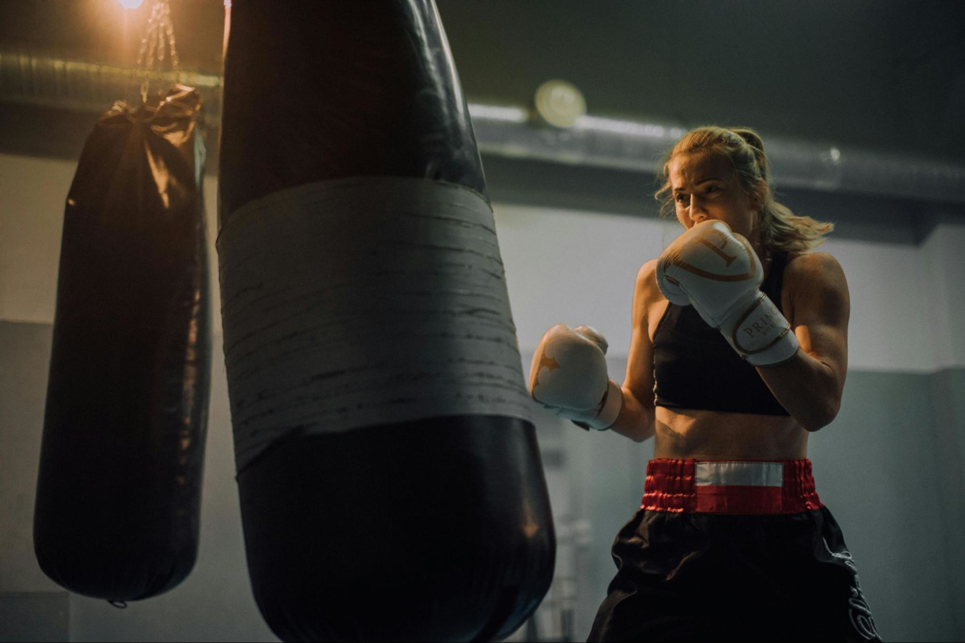 Woman does a boxing workout to manage her anger with exercise.