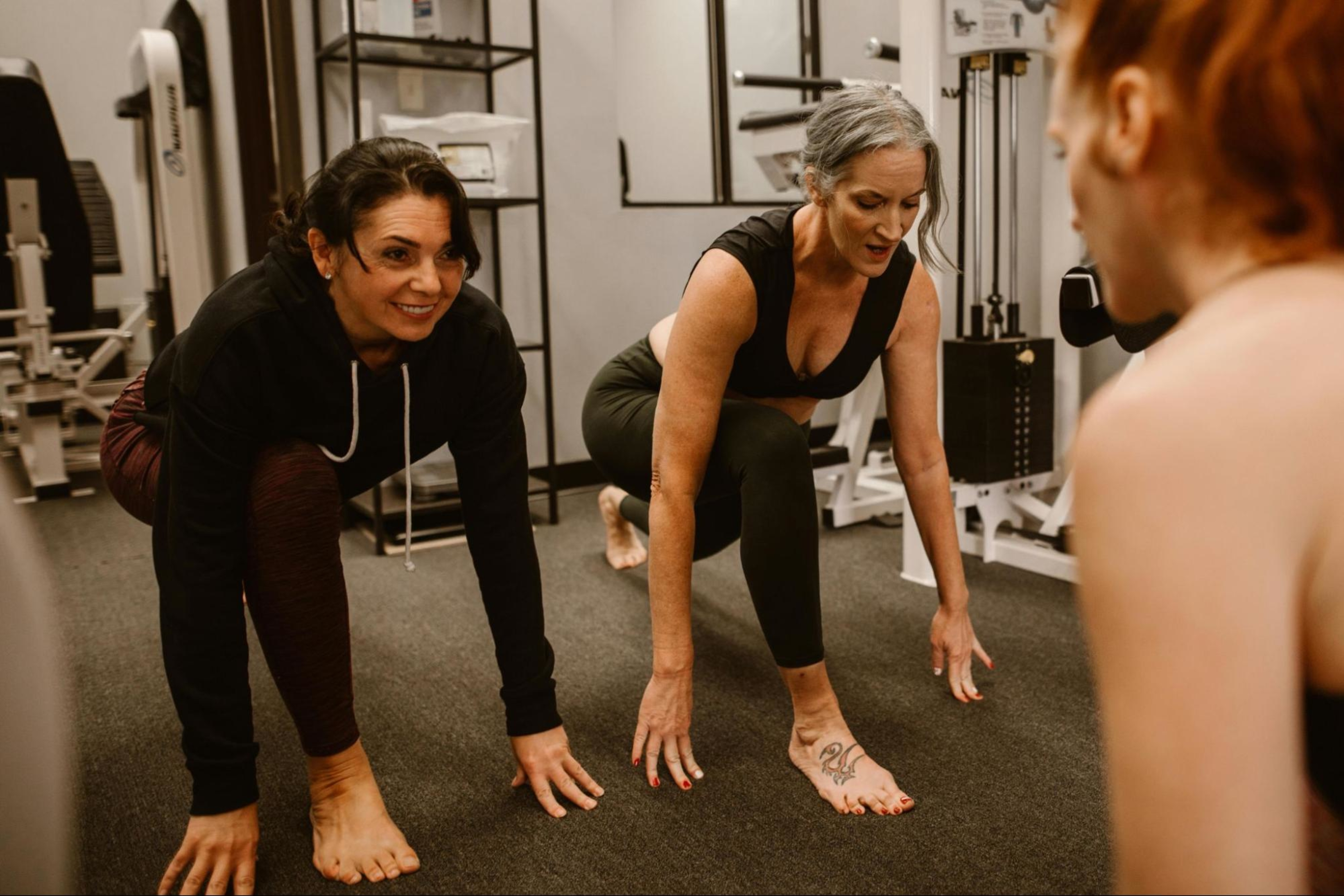 Group of women do low-impact strength exercises in a gym.