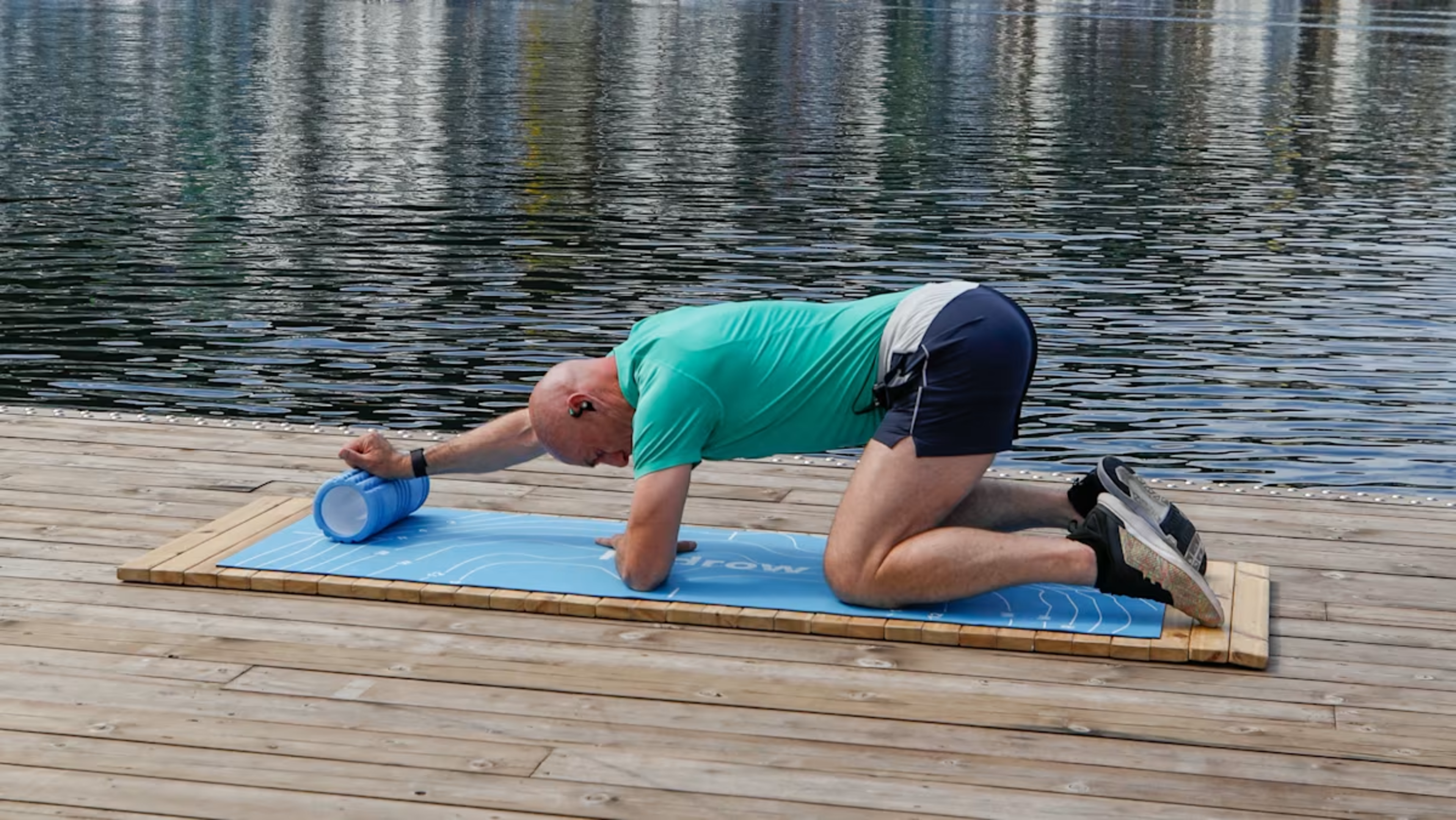 Hydrow Athlete Pete demonstrates a foam rolling exercise.