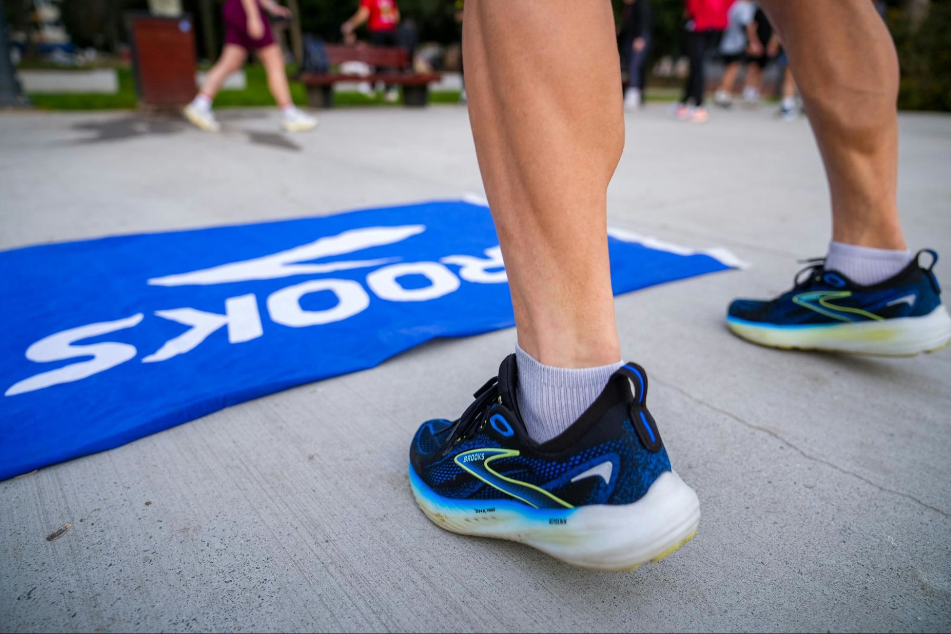 Man who has built muscle in his calves prepares to run, wearing athletic sneakers.