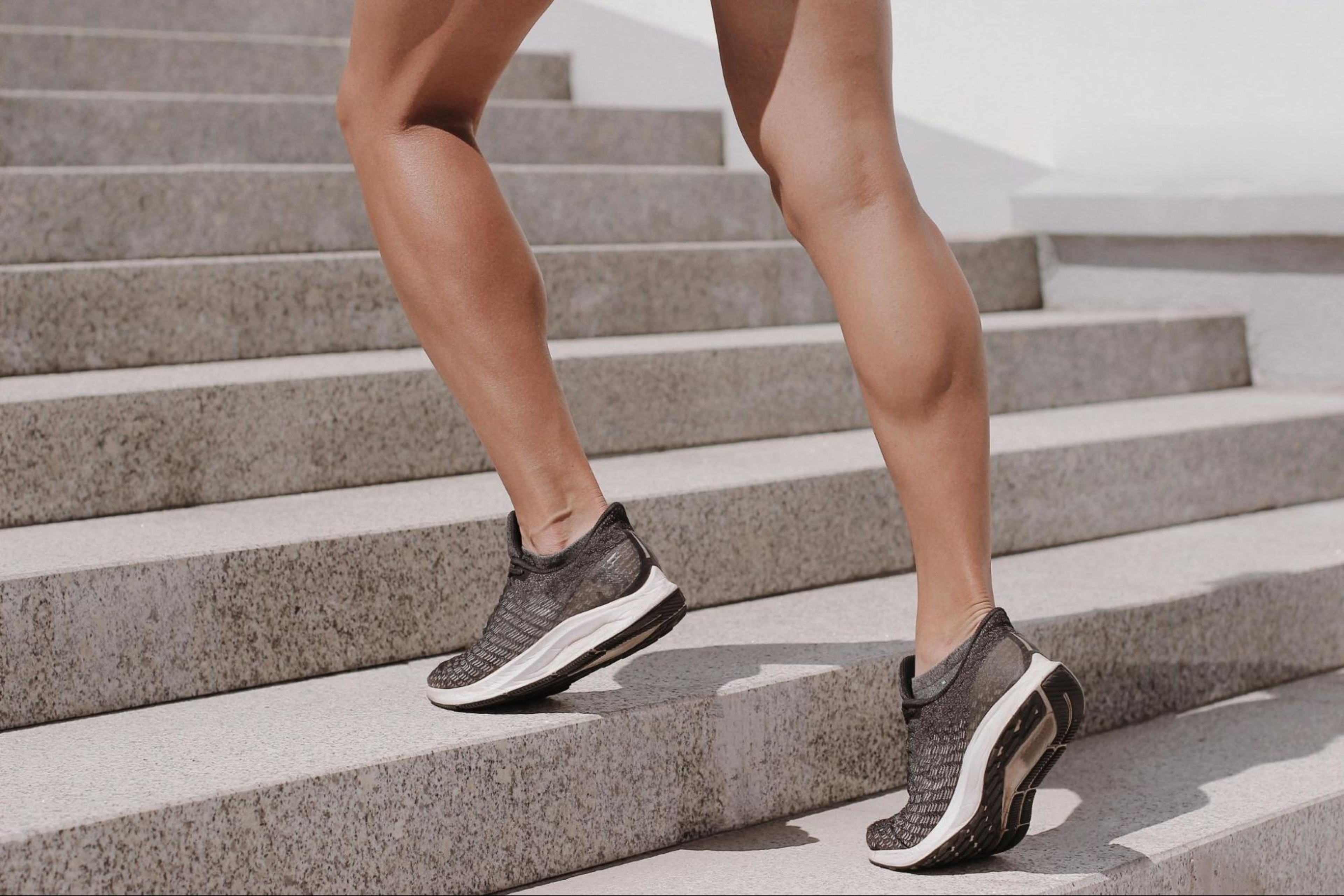 Woman runs up the stairs to build muscle mass in her calves.