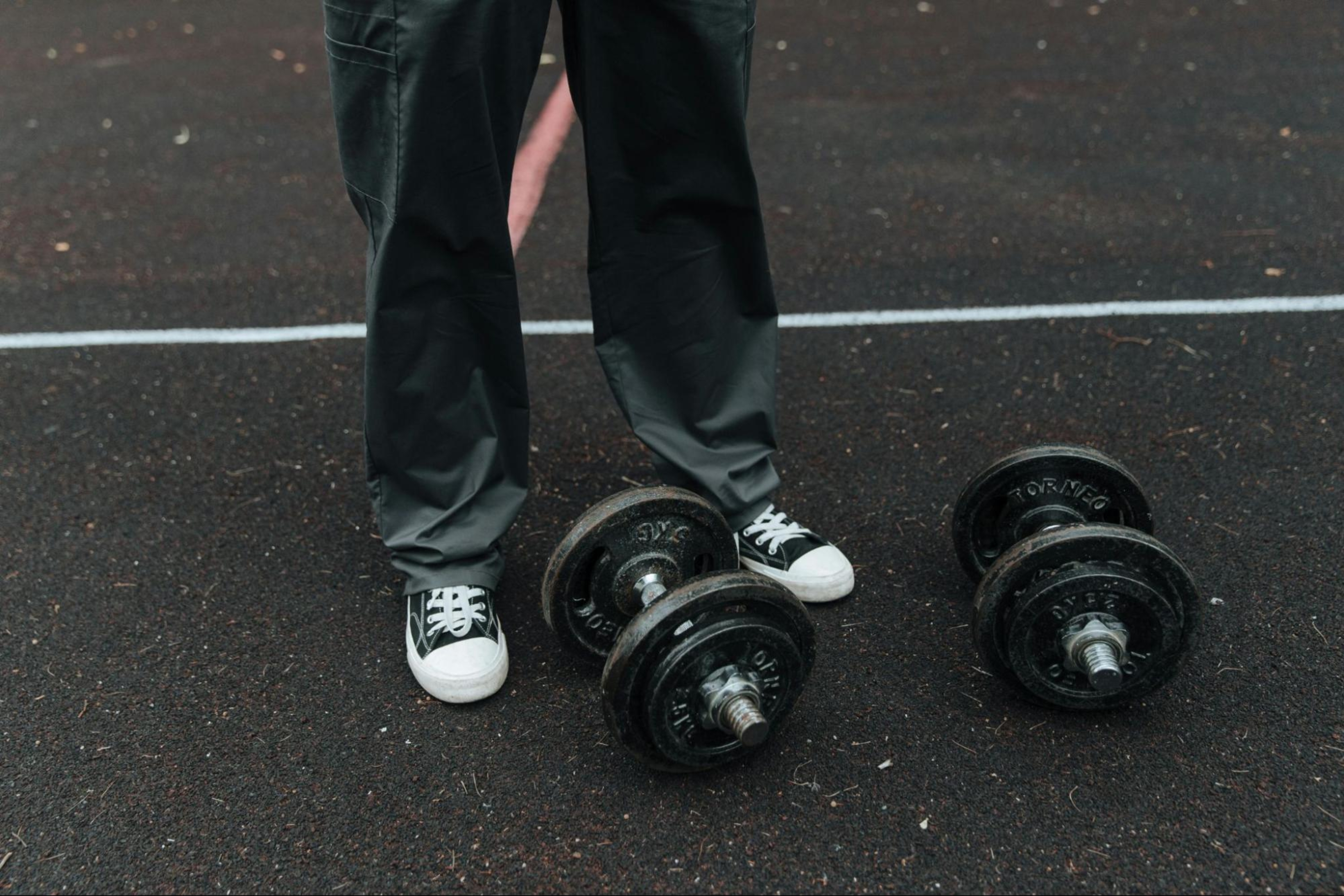 Woman uses dumbbells to build calf muscle.