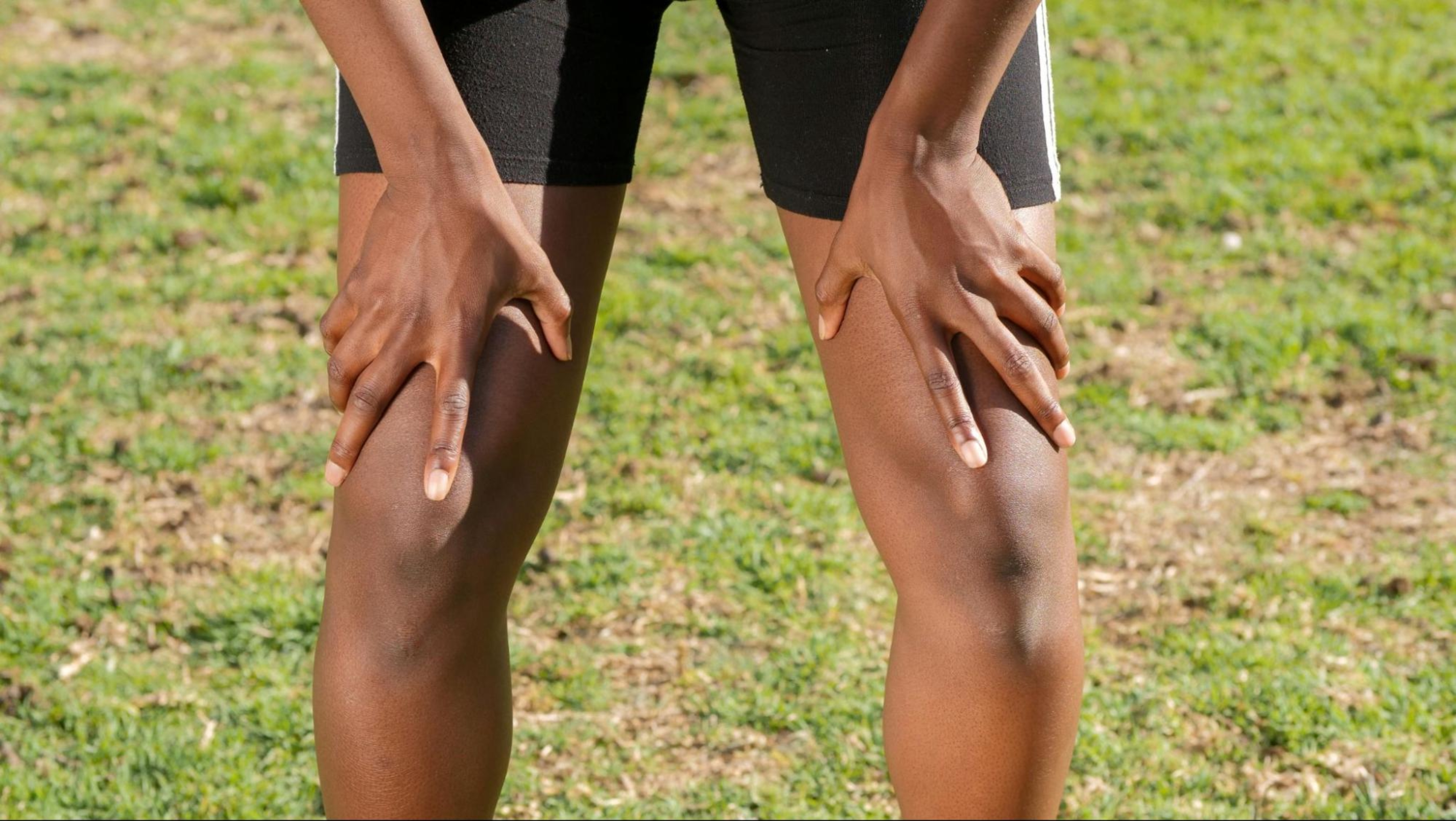 Person grips their thighs after doing exercises for thighs.