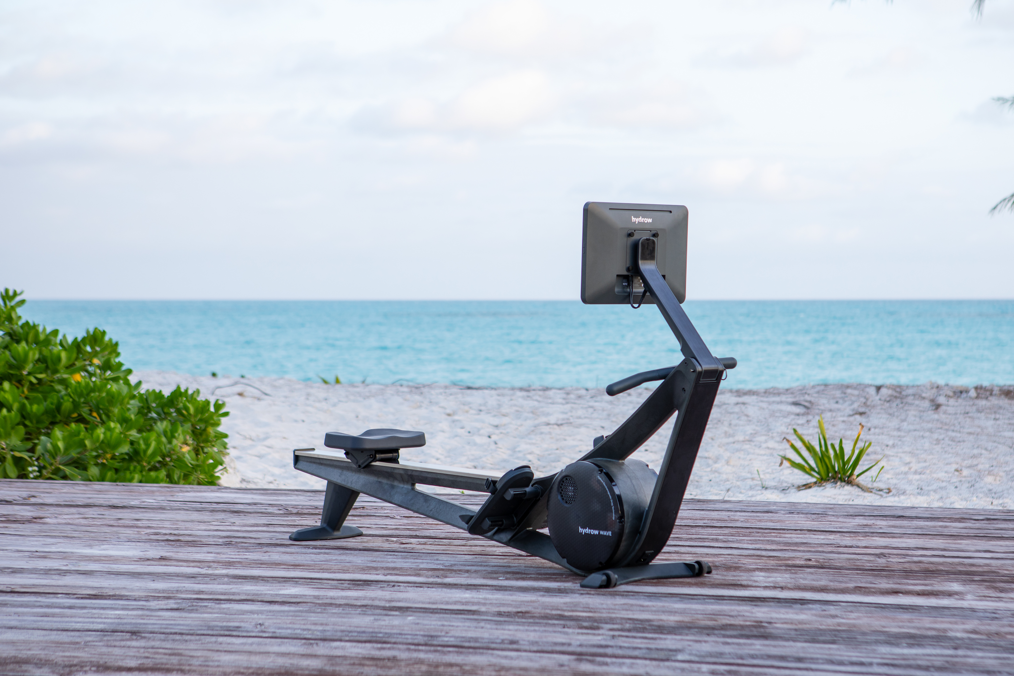 A Hydrow Wave rowing machine on a beach.