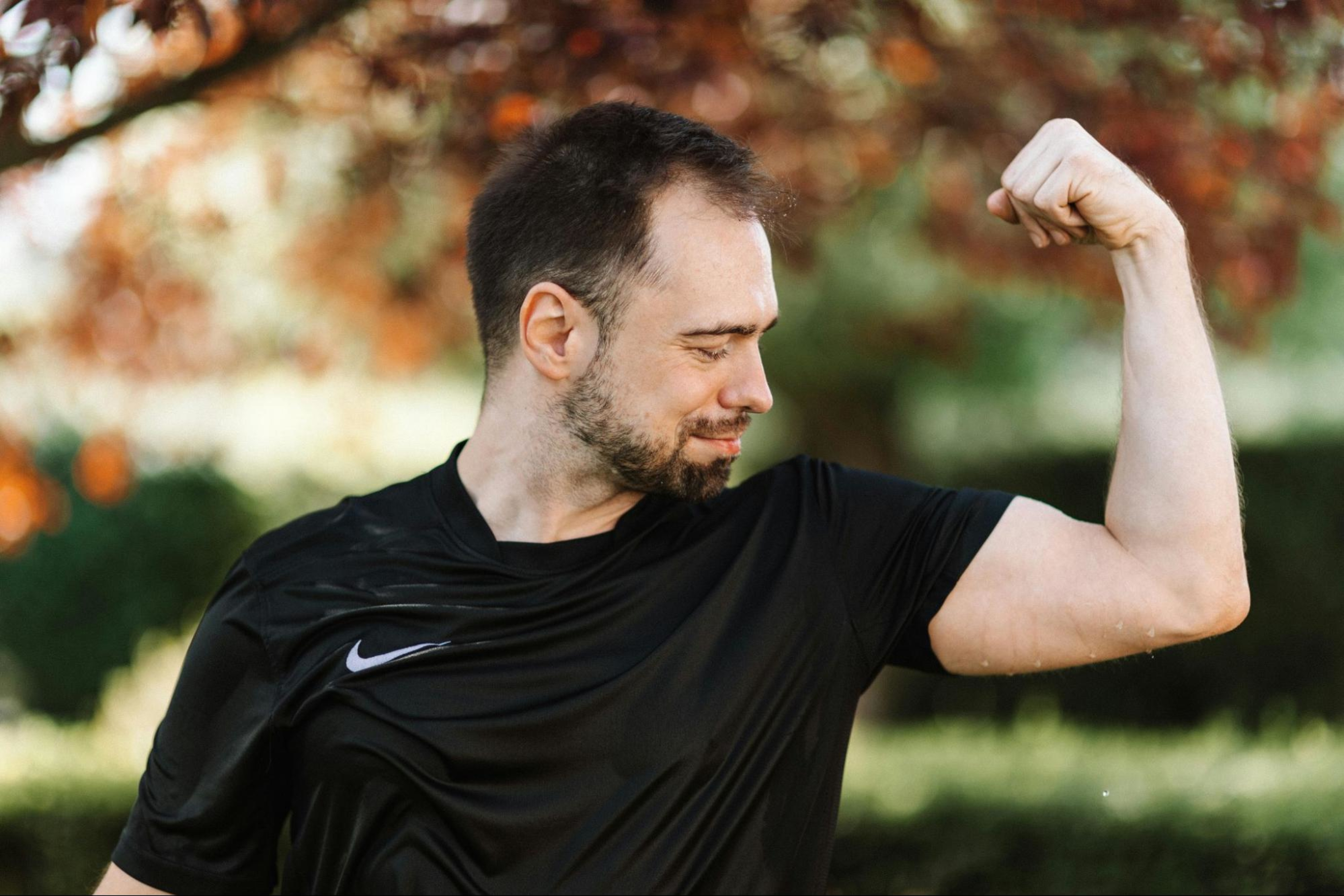 Man flexes arm muscle.