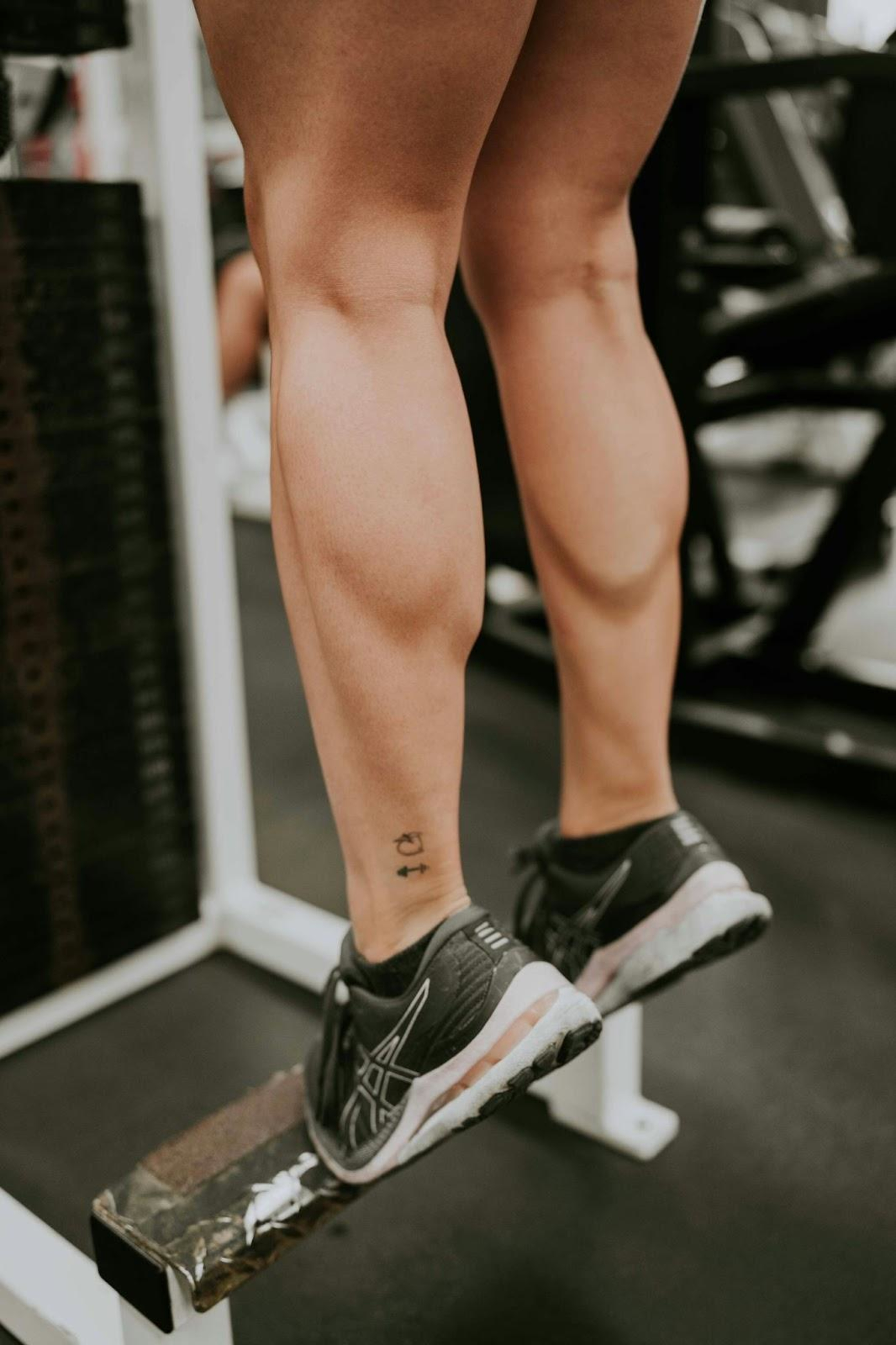 Woman does calf raises to build leg muscles.