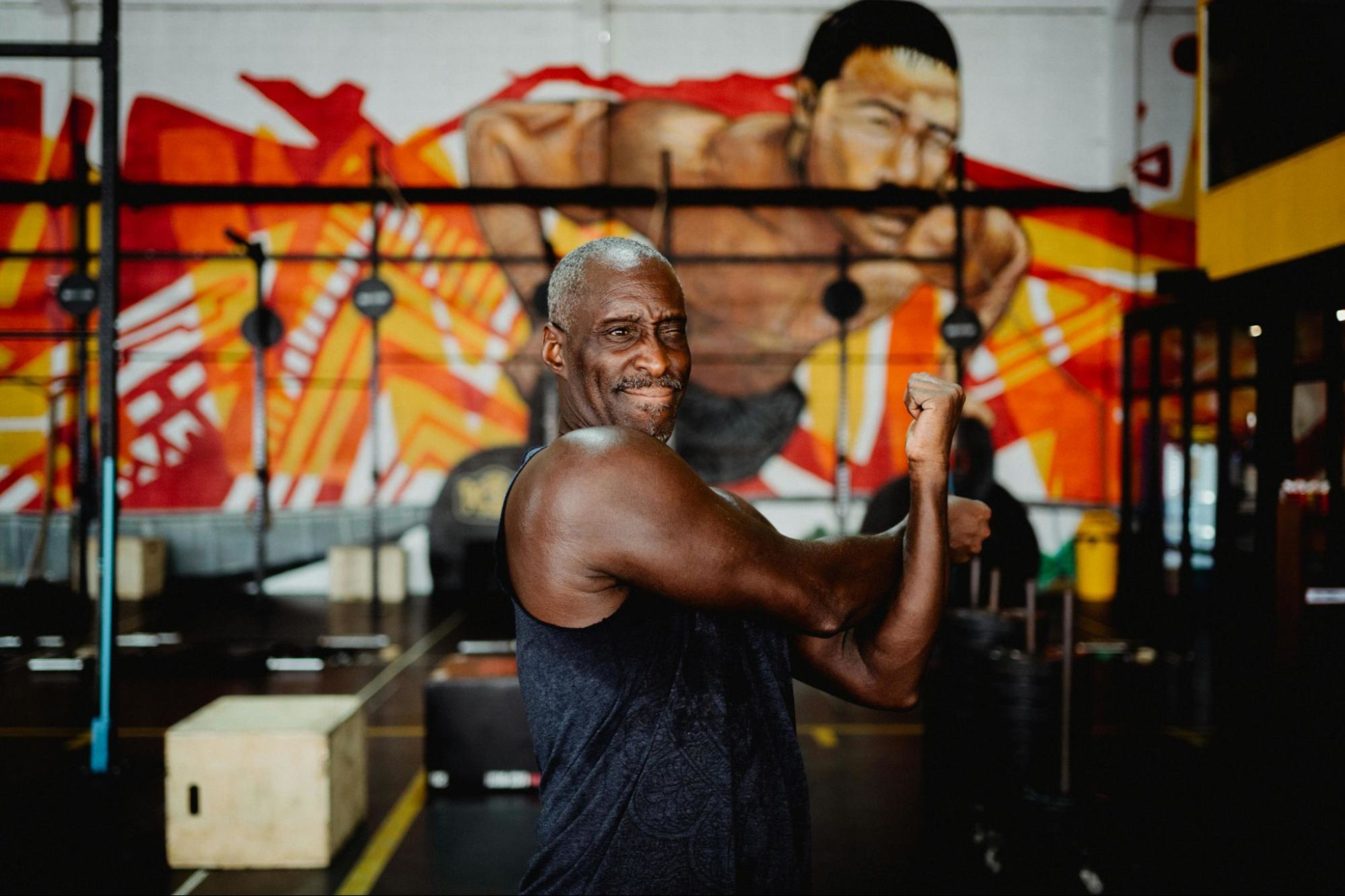 Man stretches to prepare to do a strength training workout to lower his blood pressure.