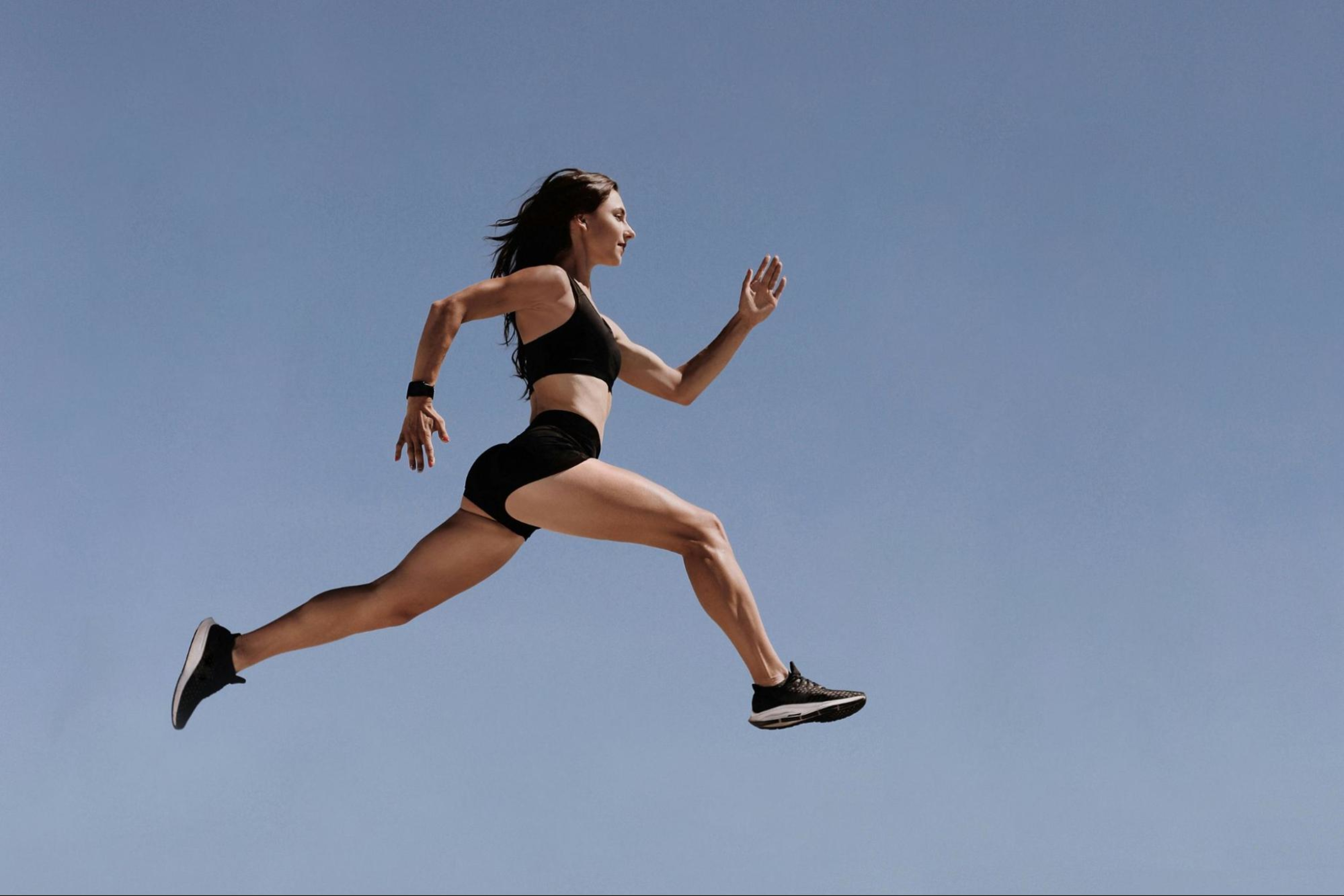 Strong woman sprints after building strong glutes.