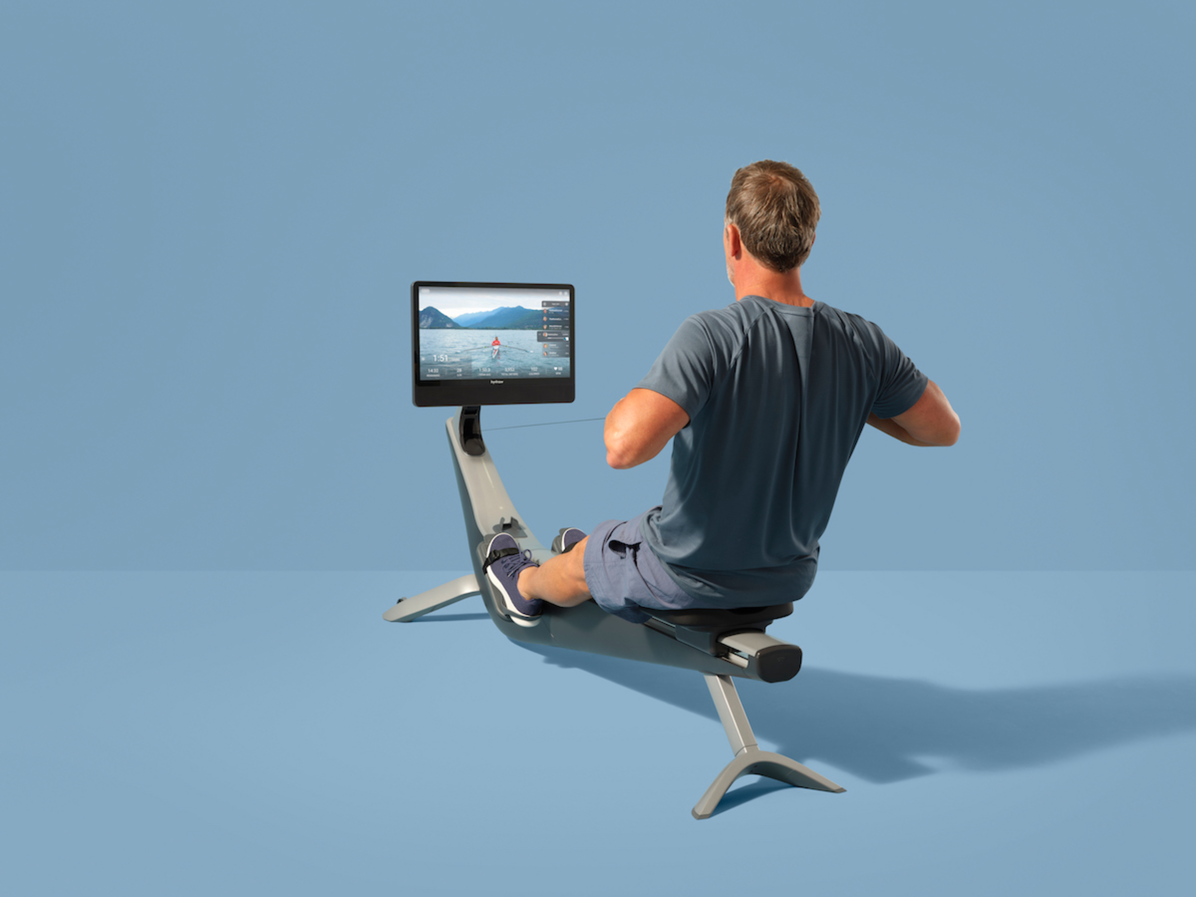 A man works out on a Hydrow Arc rowing machine.