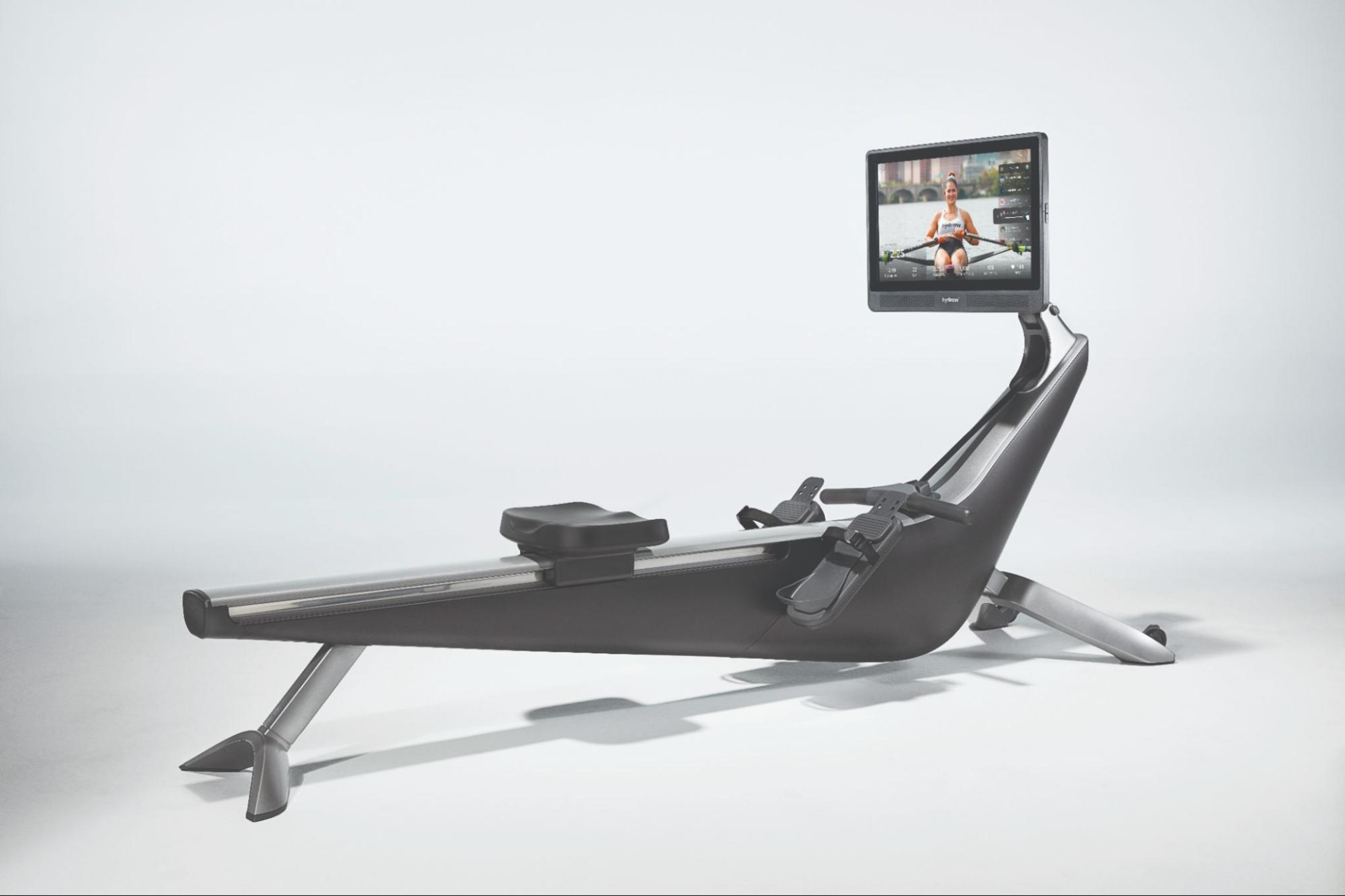 A Hydrow Origin rowing machine featuring onscreen workouts with a Hydrow Athlete.