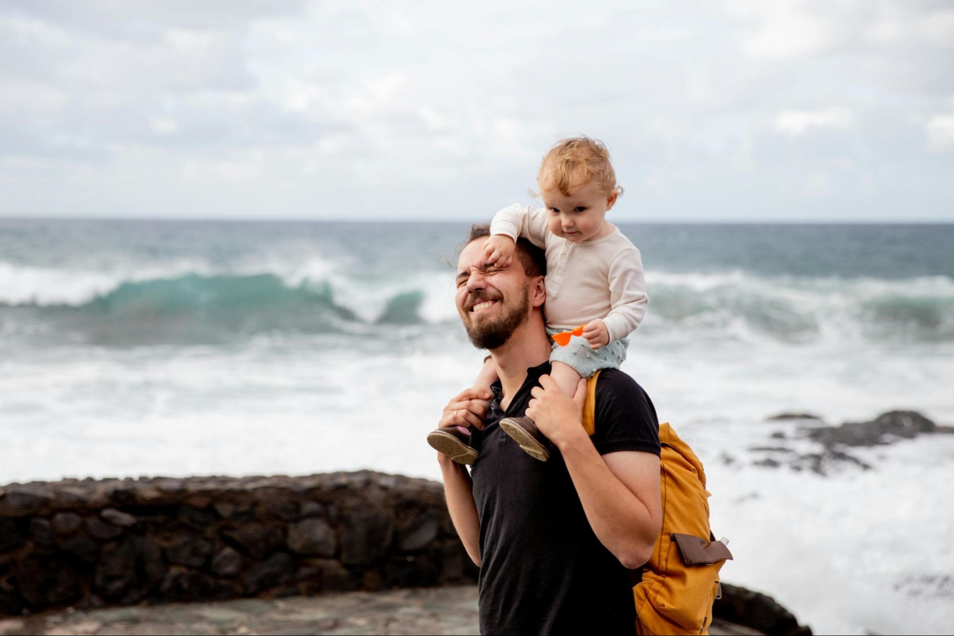 Man carries his toddler, a sign that he has built muscle.
