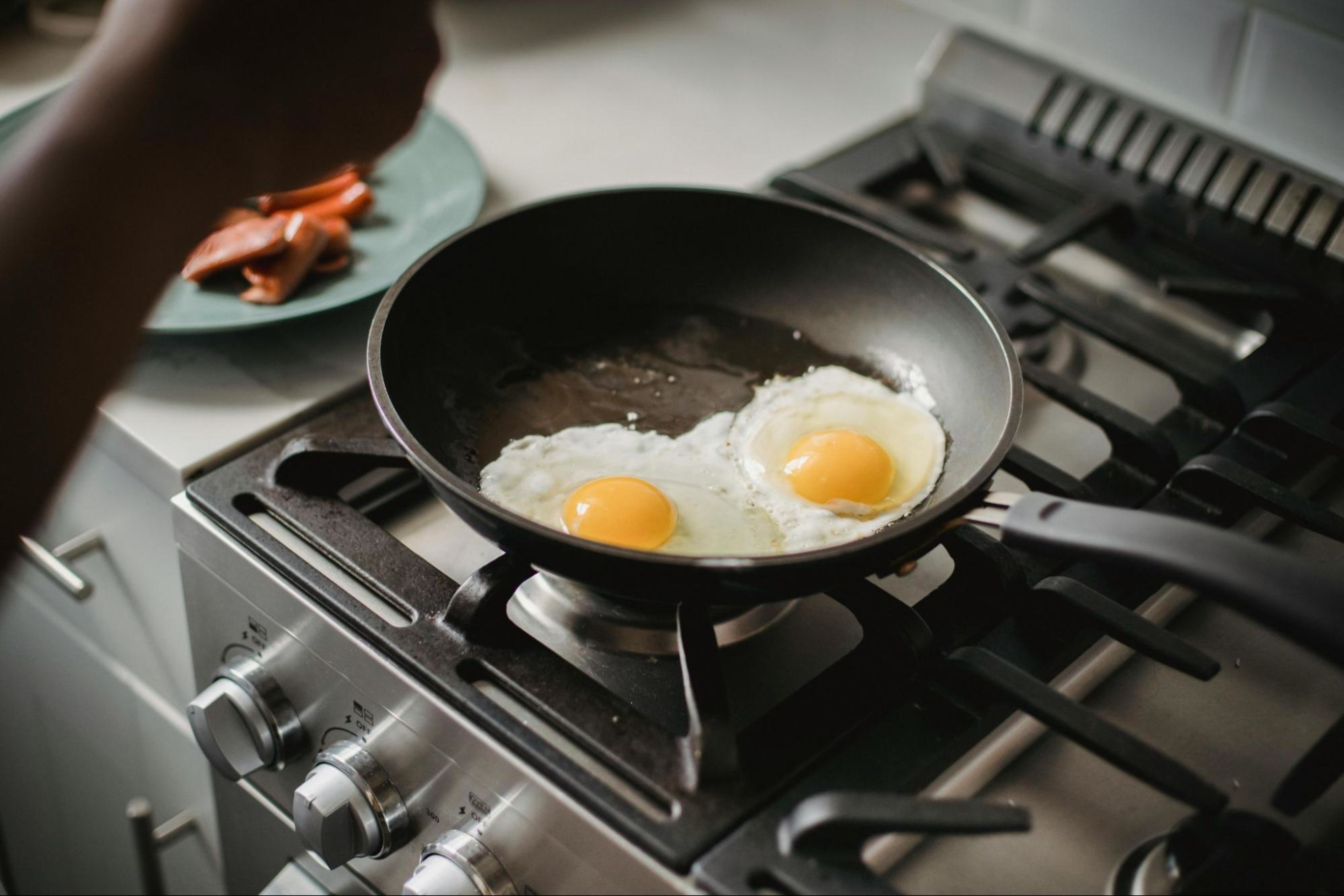 Two eggs on a frying pan to demonstrate the importance of protein when building muscle mass quickly.