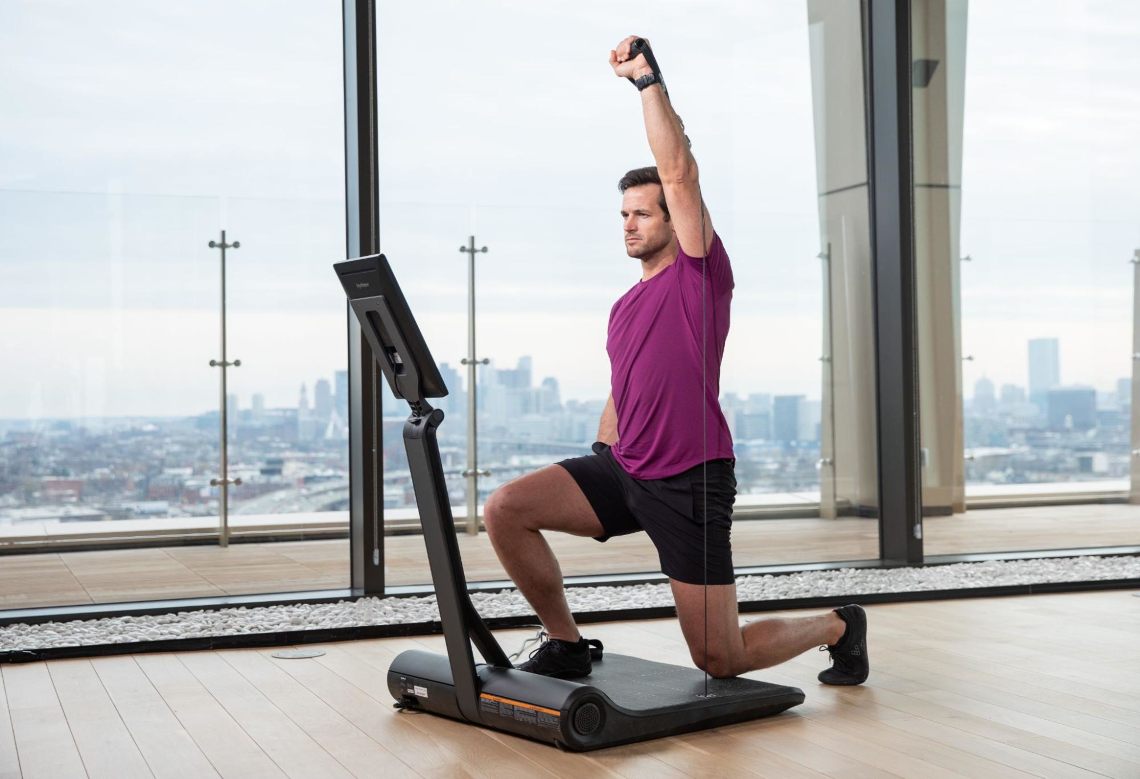 Hydrow Athlete Lance Parker leads a workout on a LYQUID strength training machine.