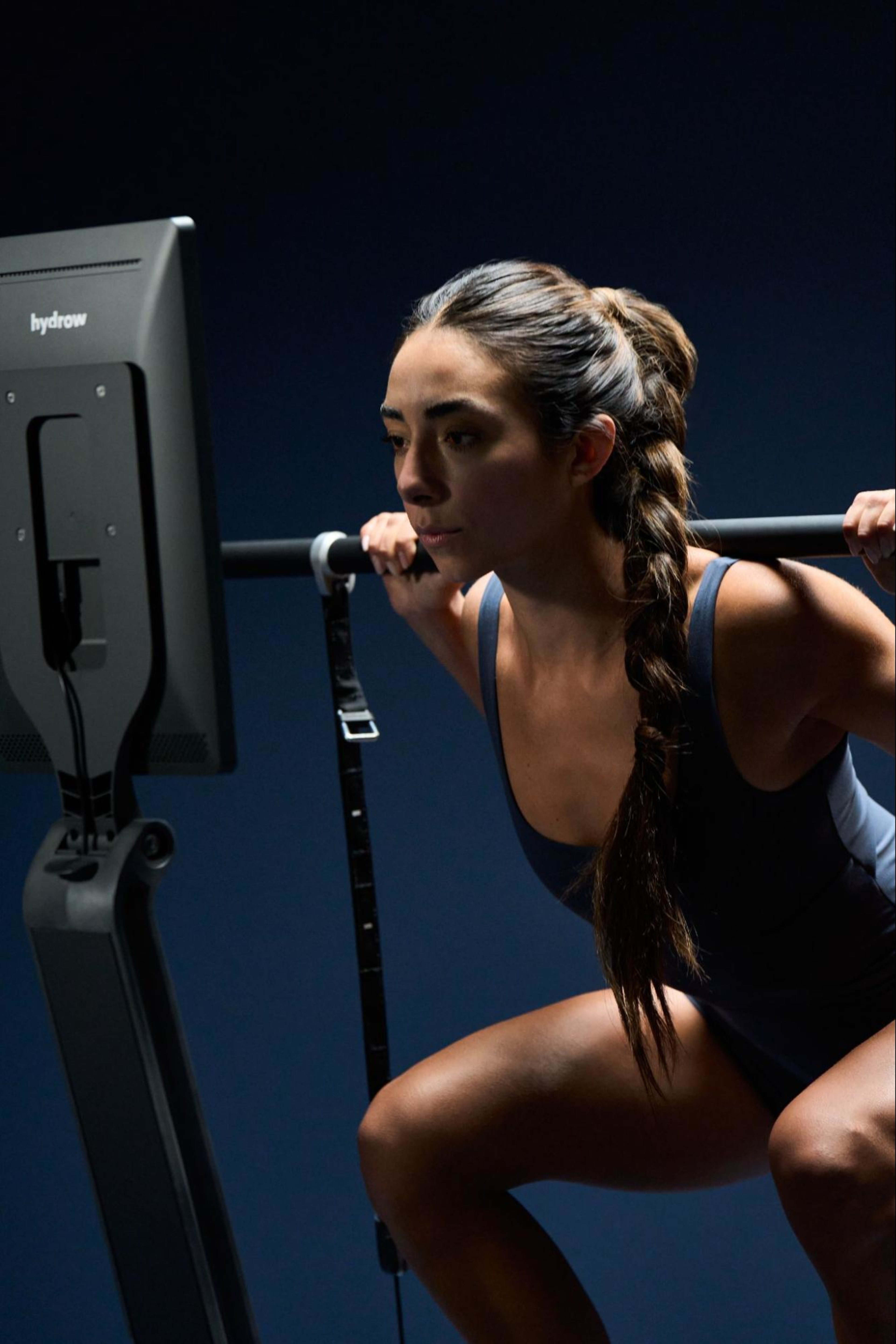 Woman does a workout on LYQUID, which uses isokinetic workout technology for highly effective workouts.