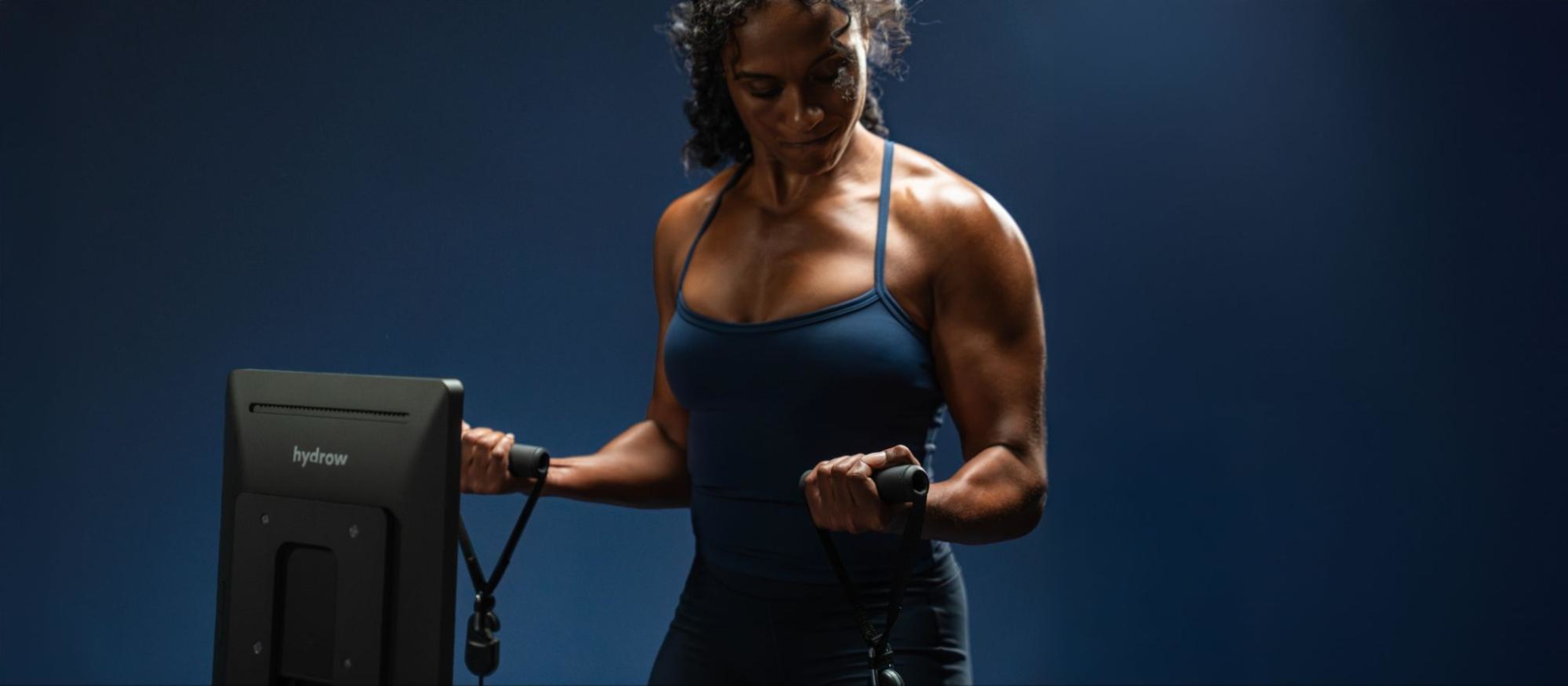 A woman does a workout using LYQUID's React Mode.