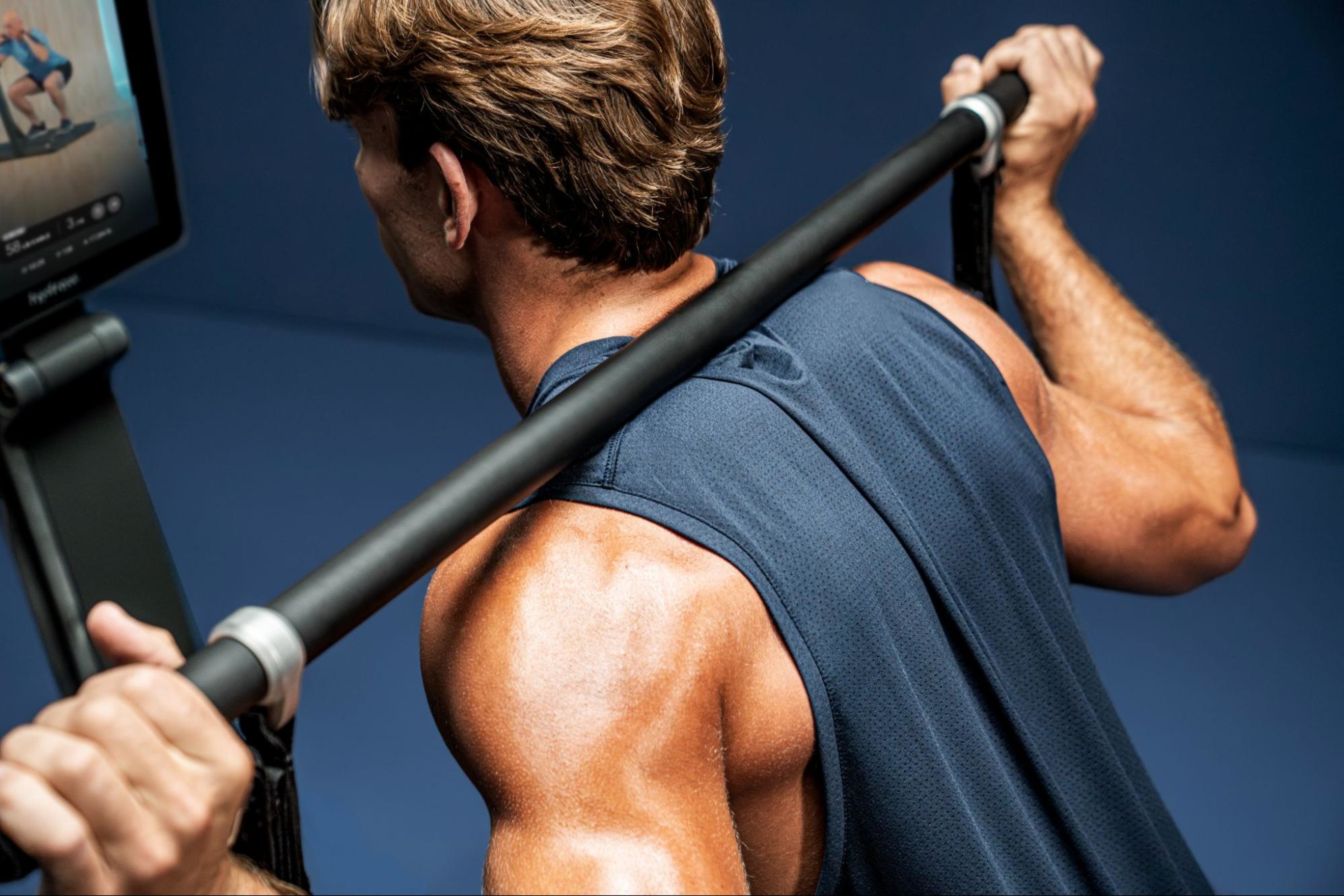A man does a workout on LYQUID, which can reach up to 500 lbs of resistance.