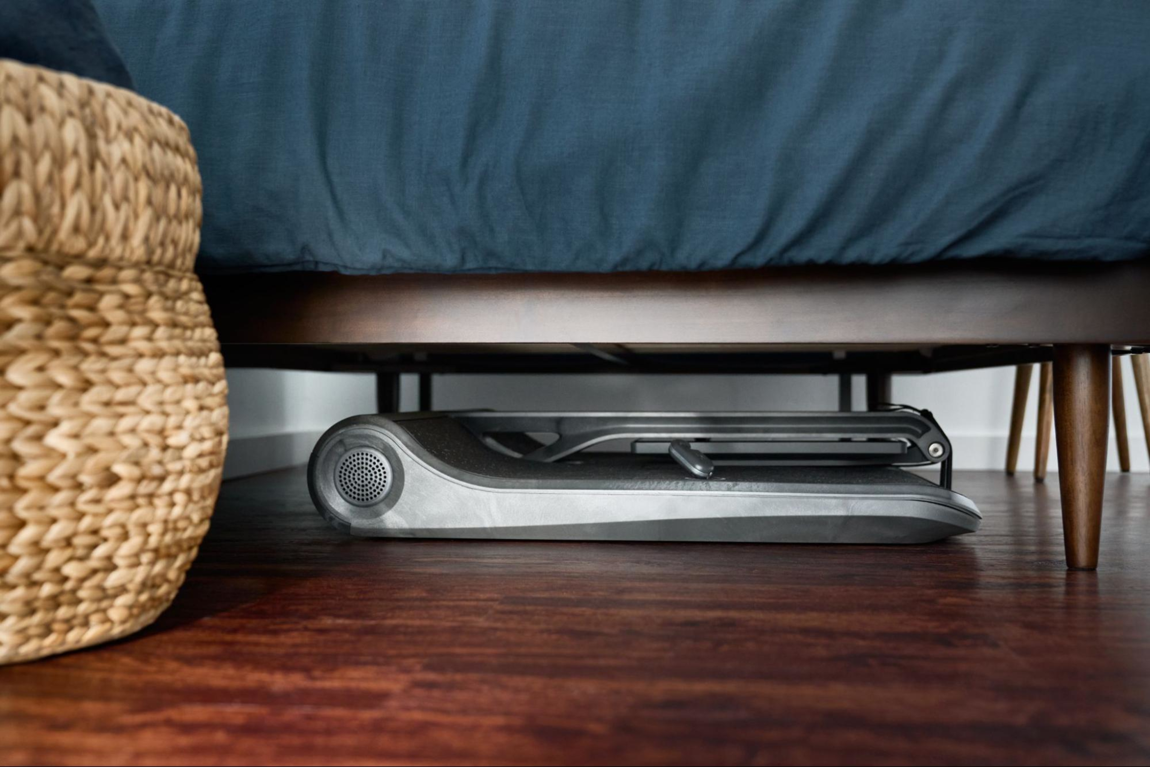 A LYQUID strength machine folded up under a bed.