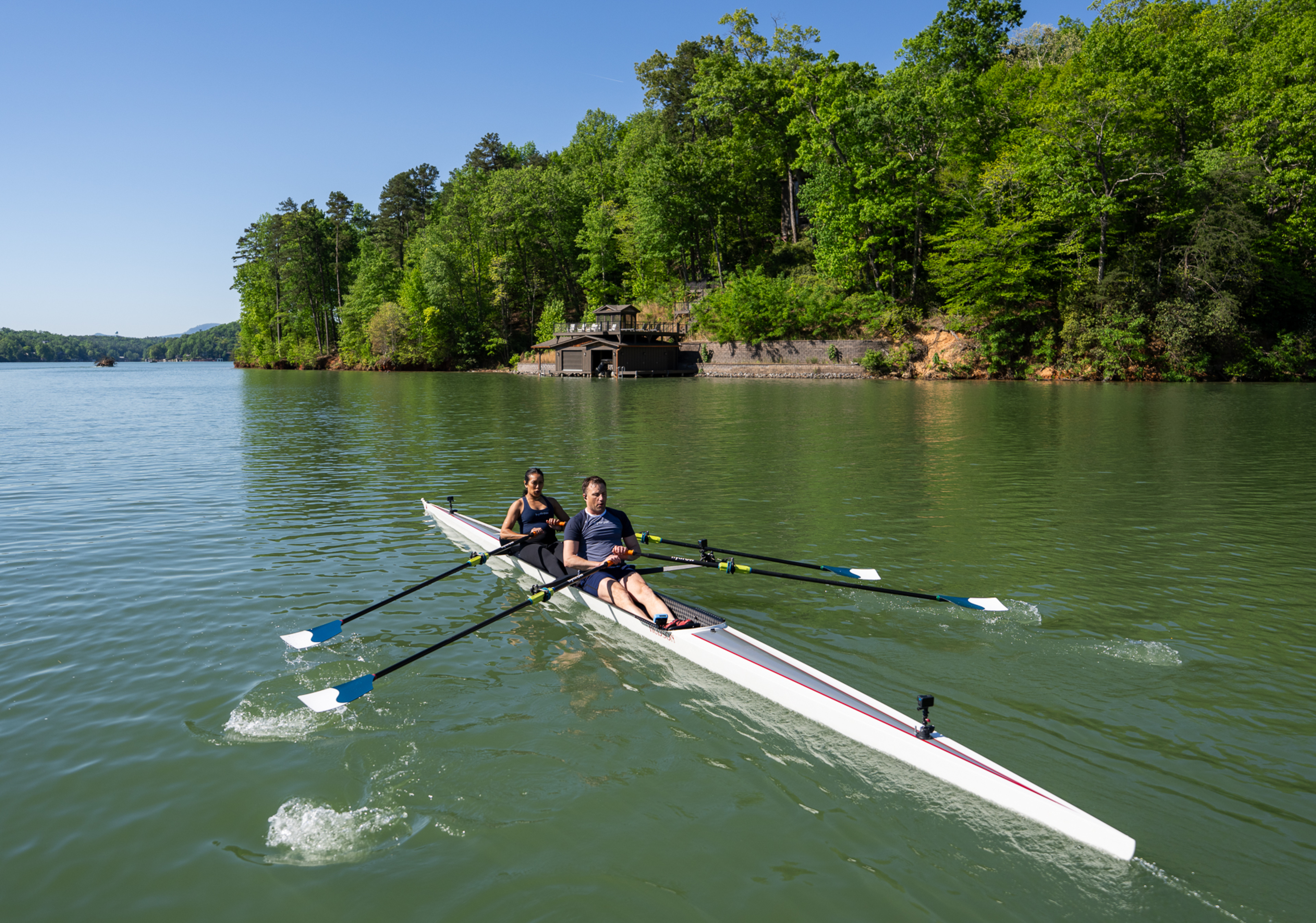 Hydrow Athletes Aisyah and Mike row on Lake Lure, Hydrow's latest destination.