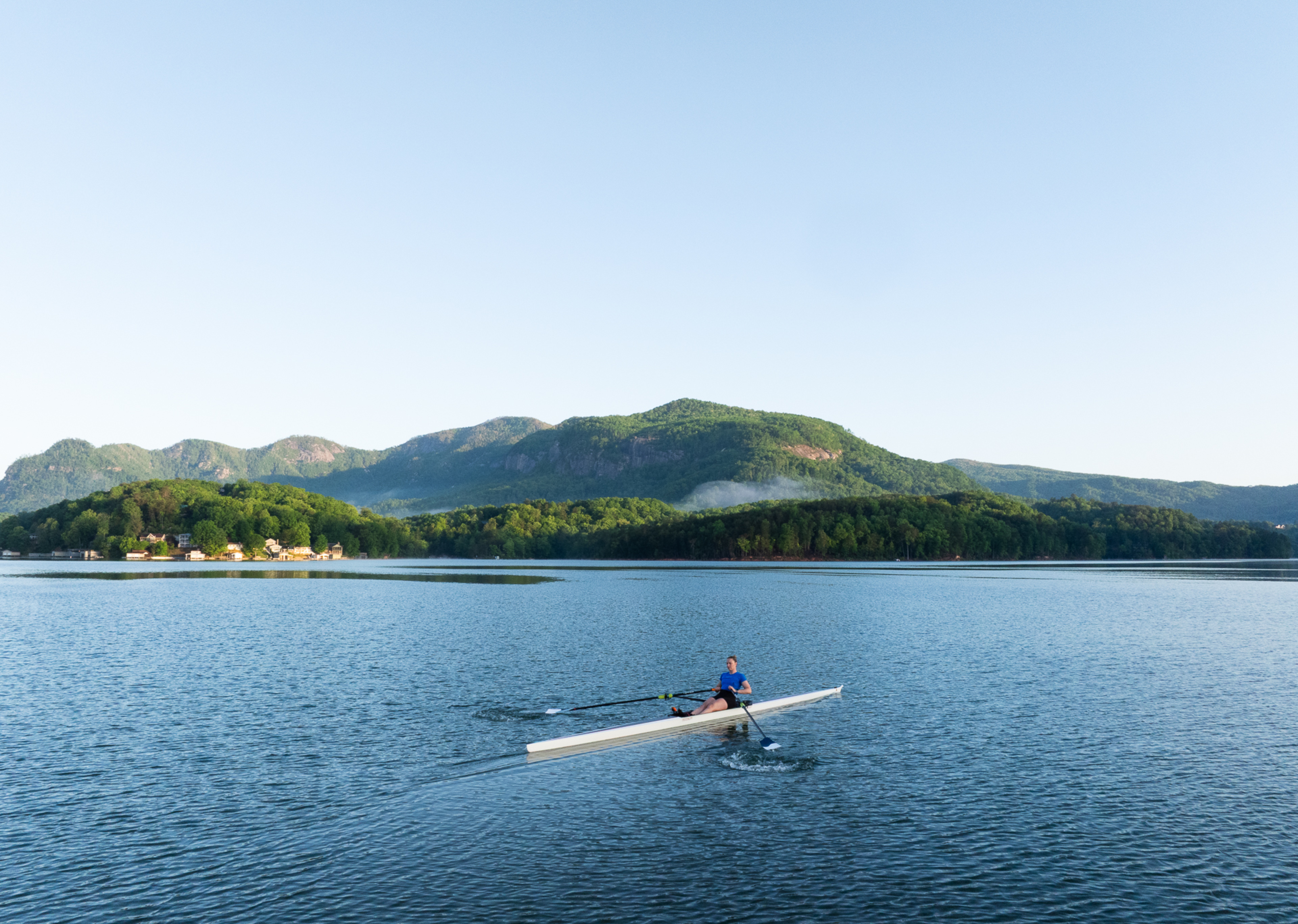 Hydrow Athlete Mac rows on Lake Lure, Hydrow's latest destination.