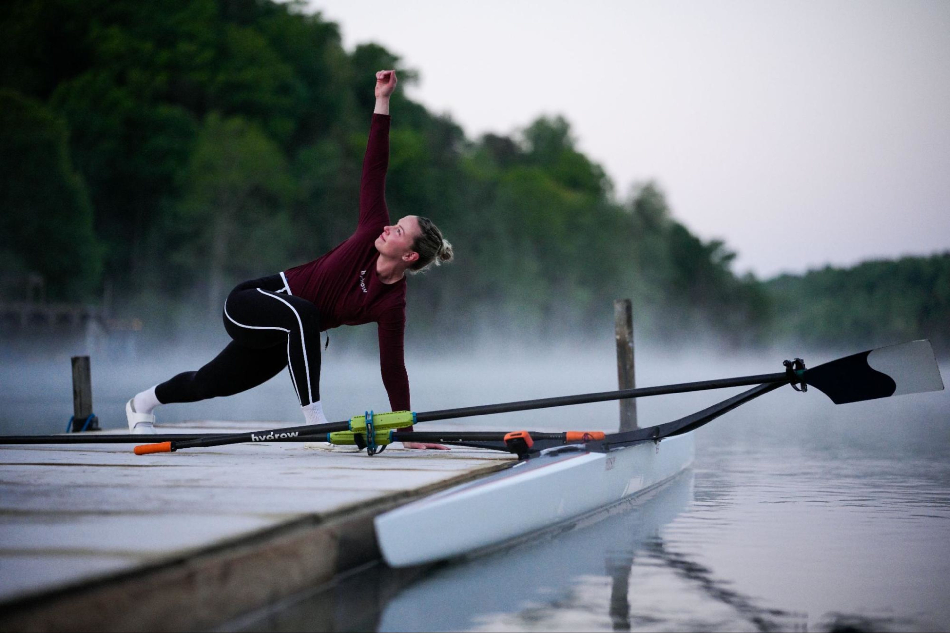 Hydrow Athlete Mac prepares for a row on Lake Lure, Hydrow's latest destination.