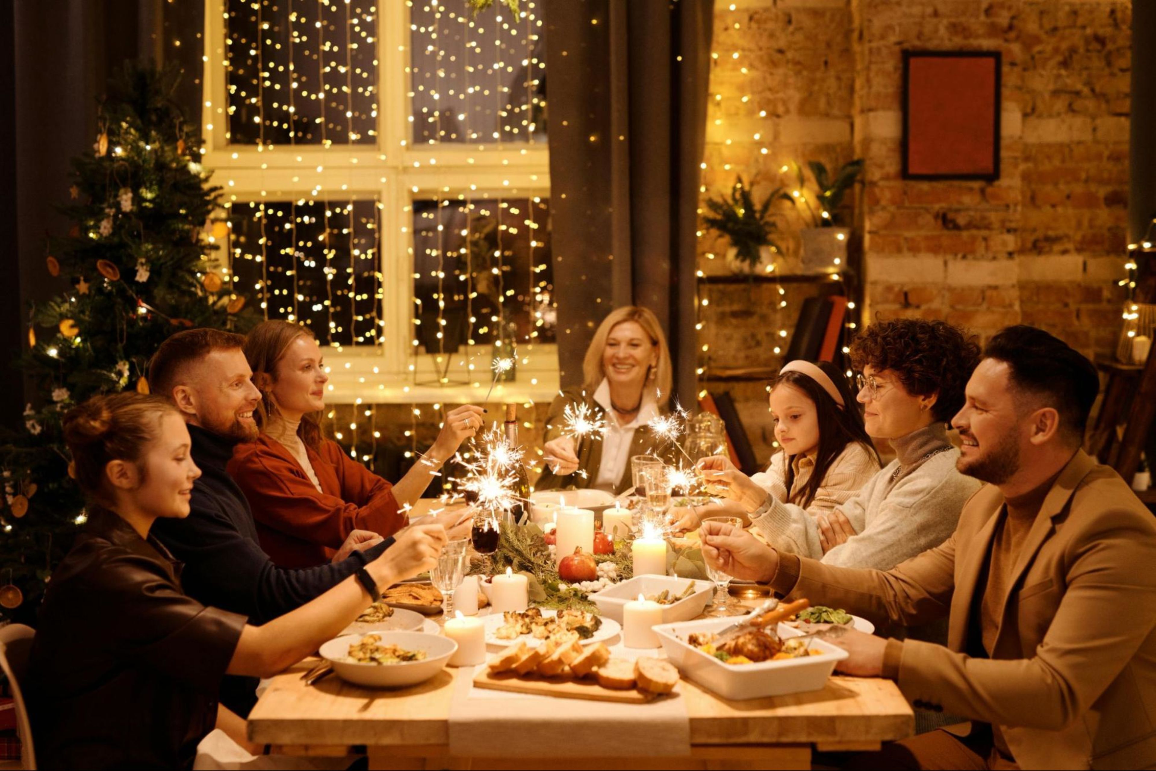 Family gathers for a holiday dinner with sparklers with the goal of healthy holiday eating.