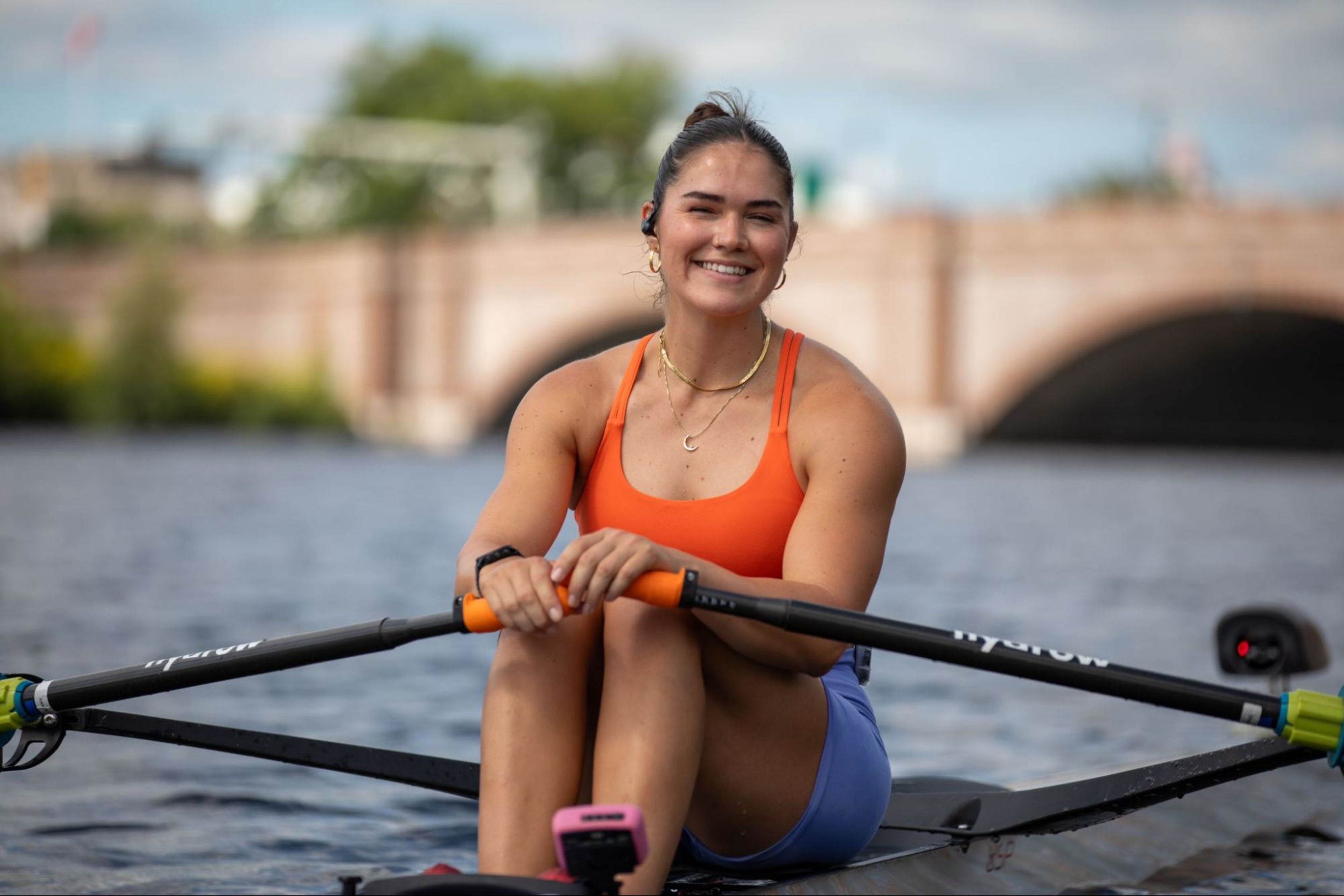 Hydrow Athlete Sera rows on the water for a Hydrow workout, which can now be scheduled in your calendar app ahead of time.