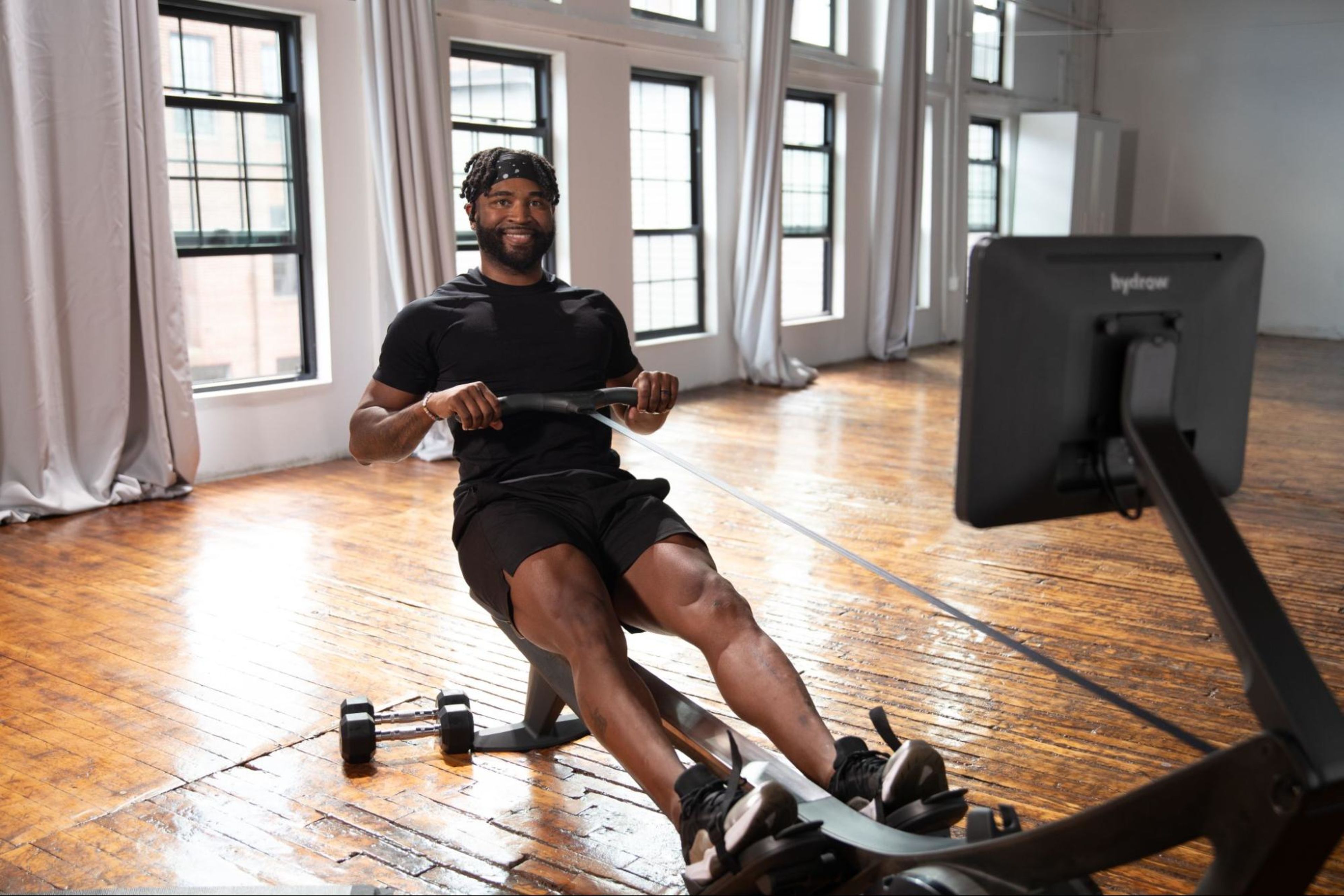 Man rows on a rowing machine as part of Hydrow's six-week fitness plan.