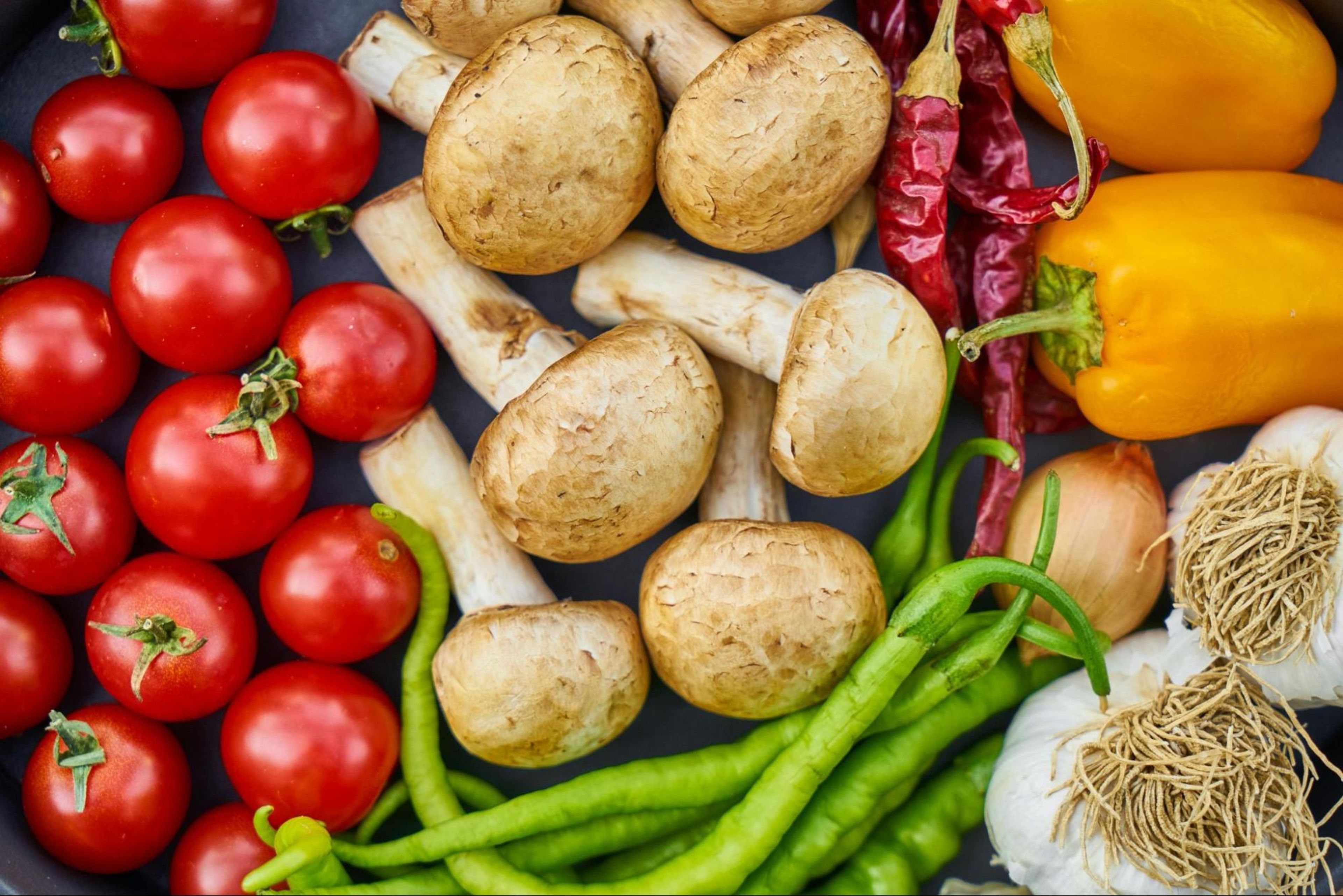 A sampling of the best vegetables to eat, including peppers, tomatoes, and mushrooms.