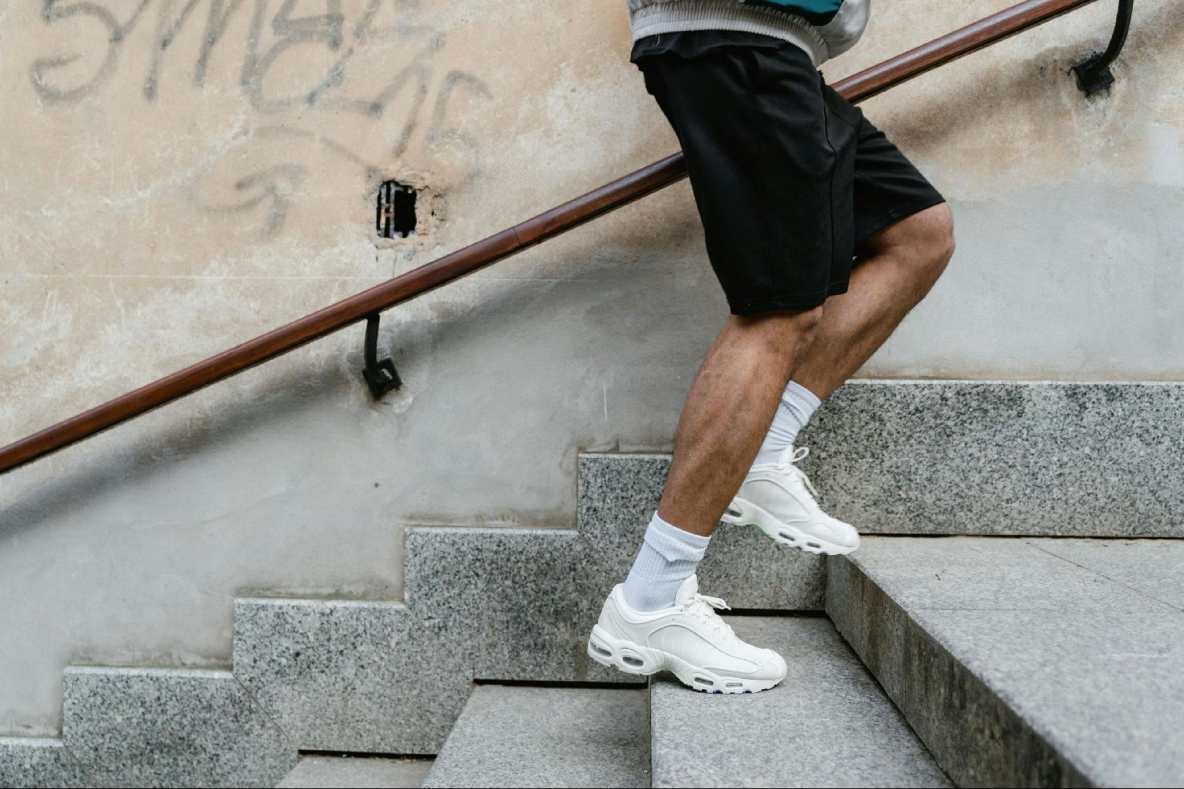 Man runs up the stairs to build calf muscles.