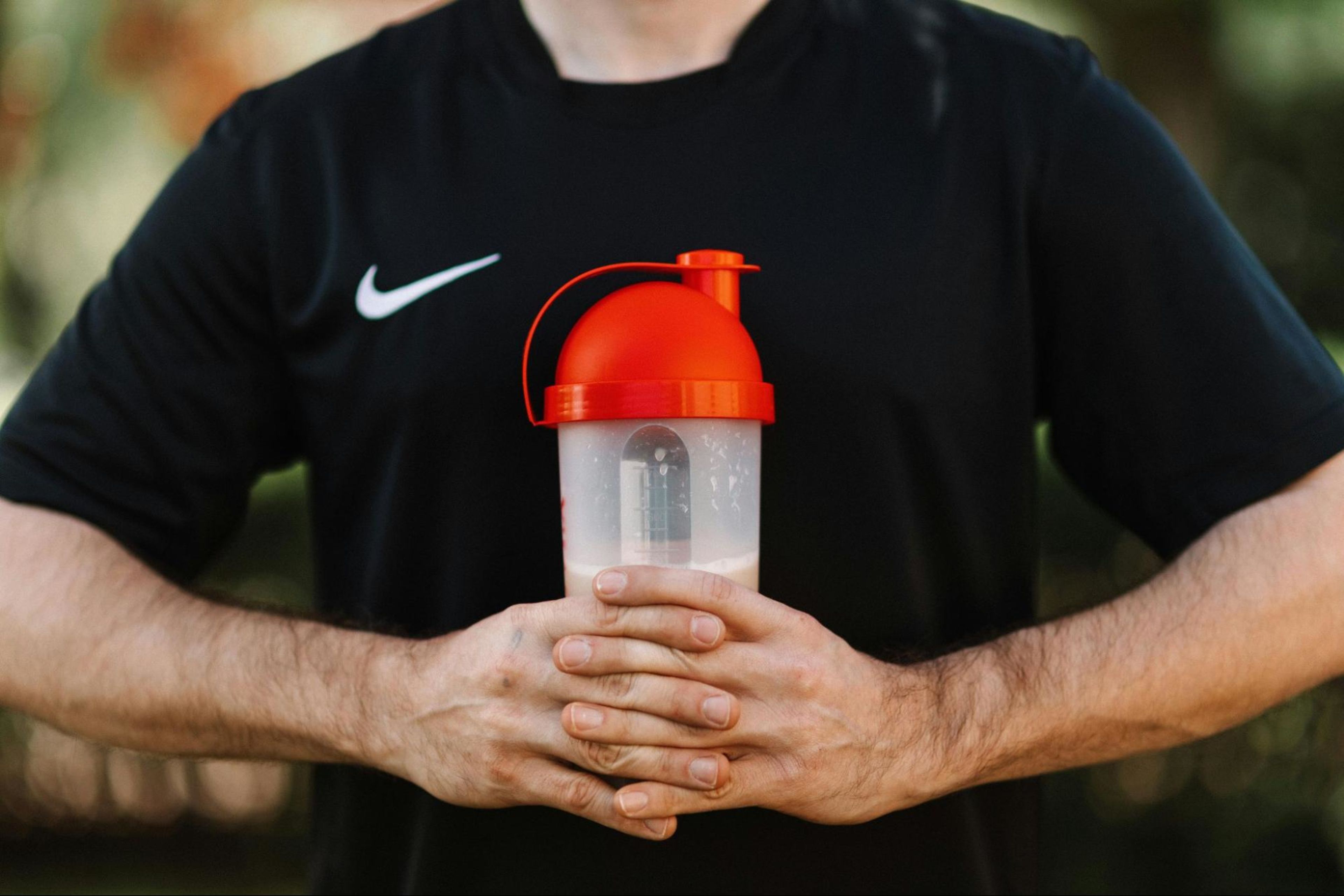 Man learns how to build forearm muscle and holds a water bottle.