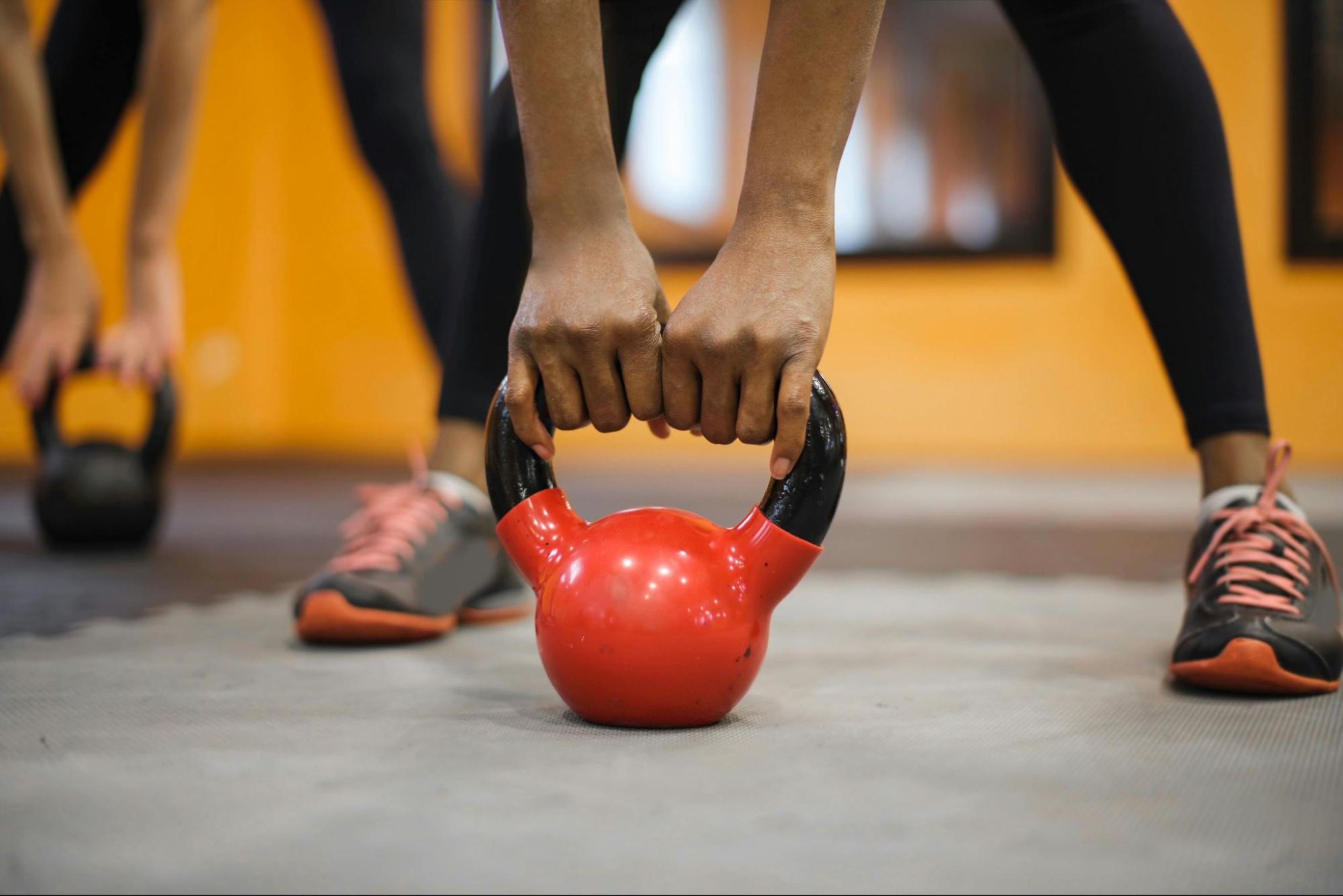 Woman does a kettlebell workout in a gym.