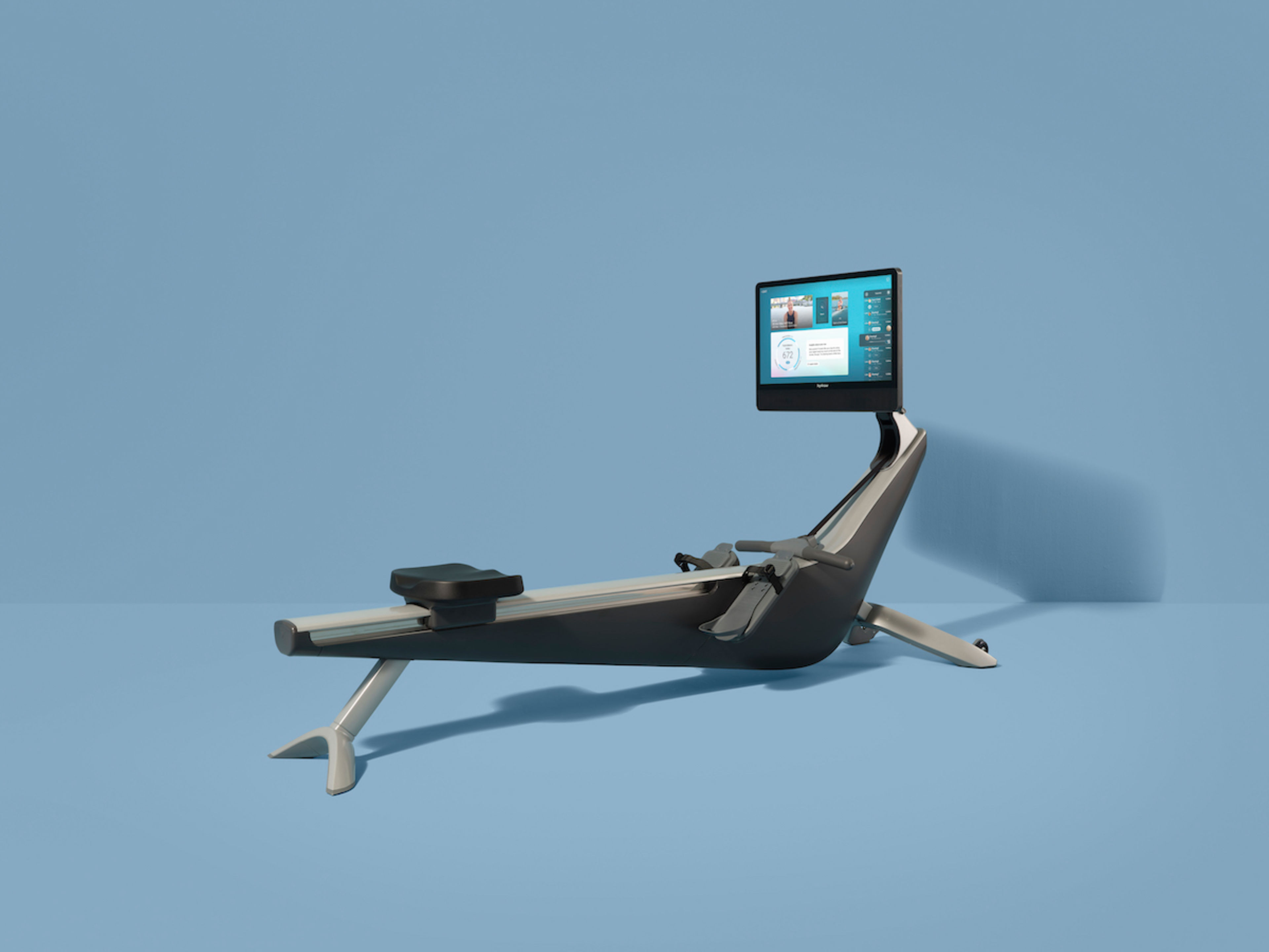 A Hydrow Arc rower against a blue background.