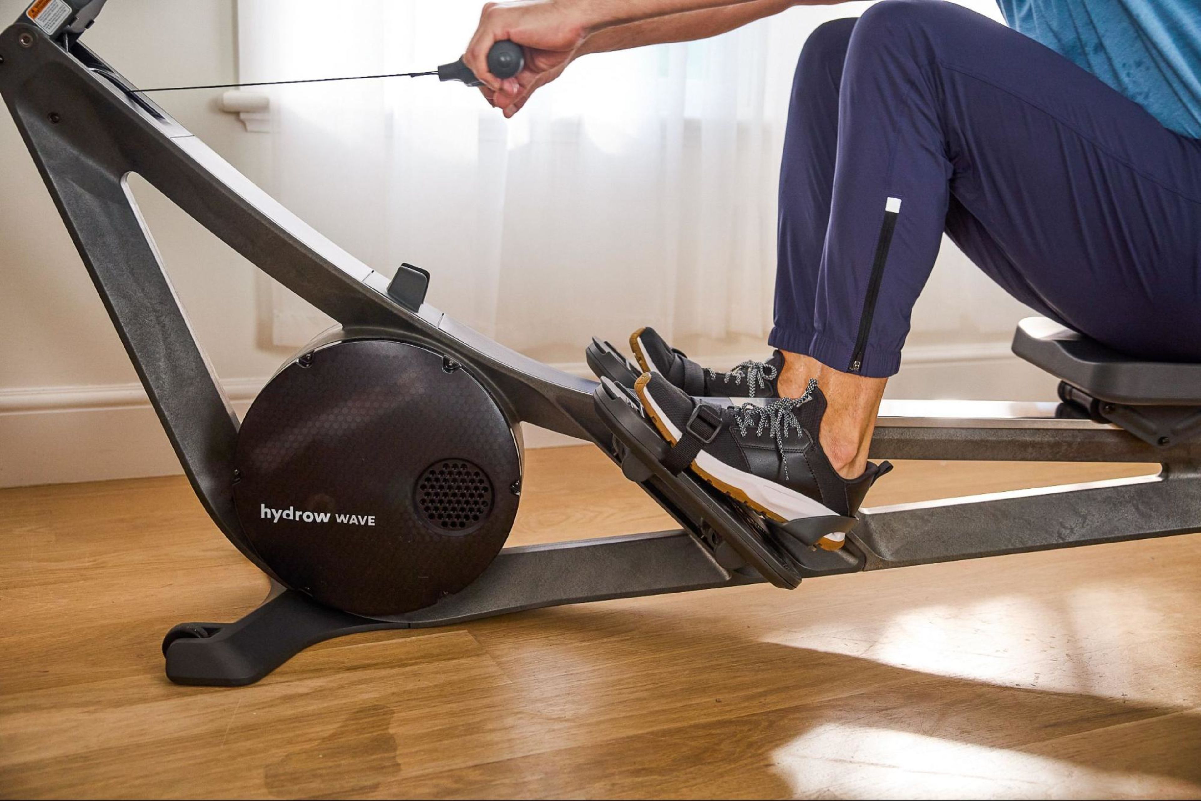 Man works out on a Hydrow rowing machine.
