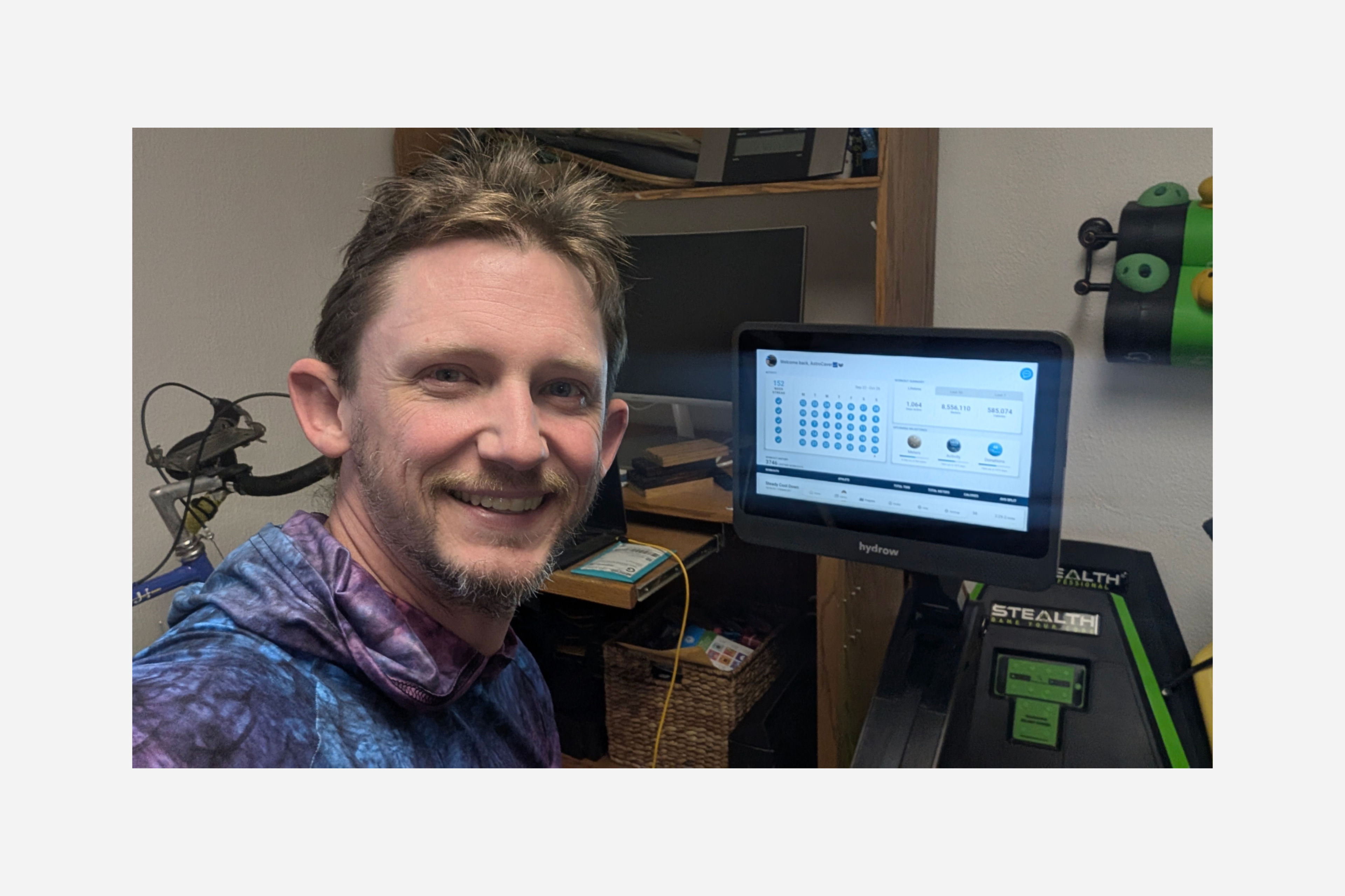 Hydrow Member Josh Sebree sits on his Hydrow rowing machine.